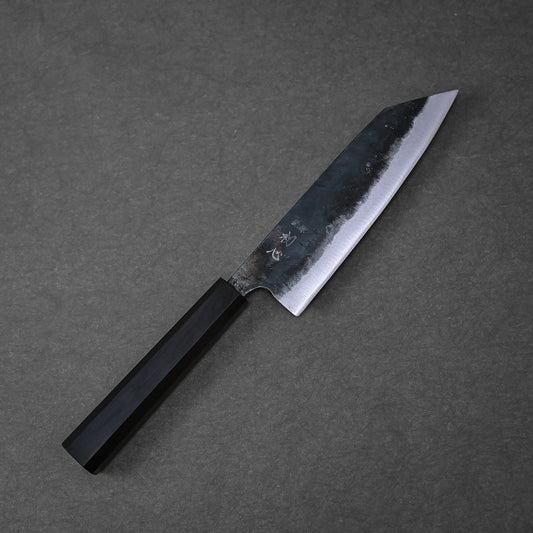 The Hatsukokoro kurouchi aogami#2 bunka 165mm kitchen knife by Hatsukokoro, featuring a dark wooden handle and a partially polished, partially kurouchi blade, rests on a gray textured surface.