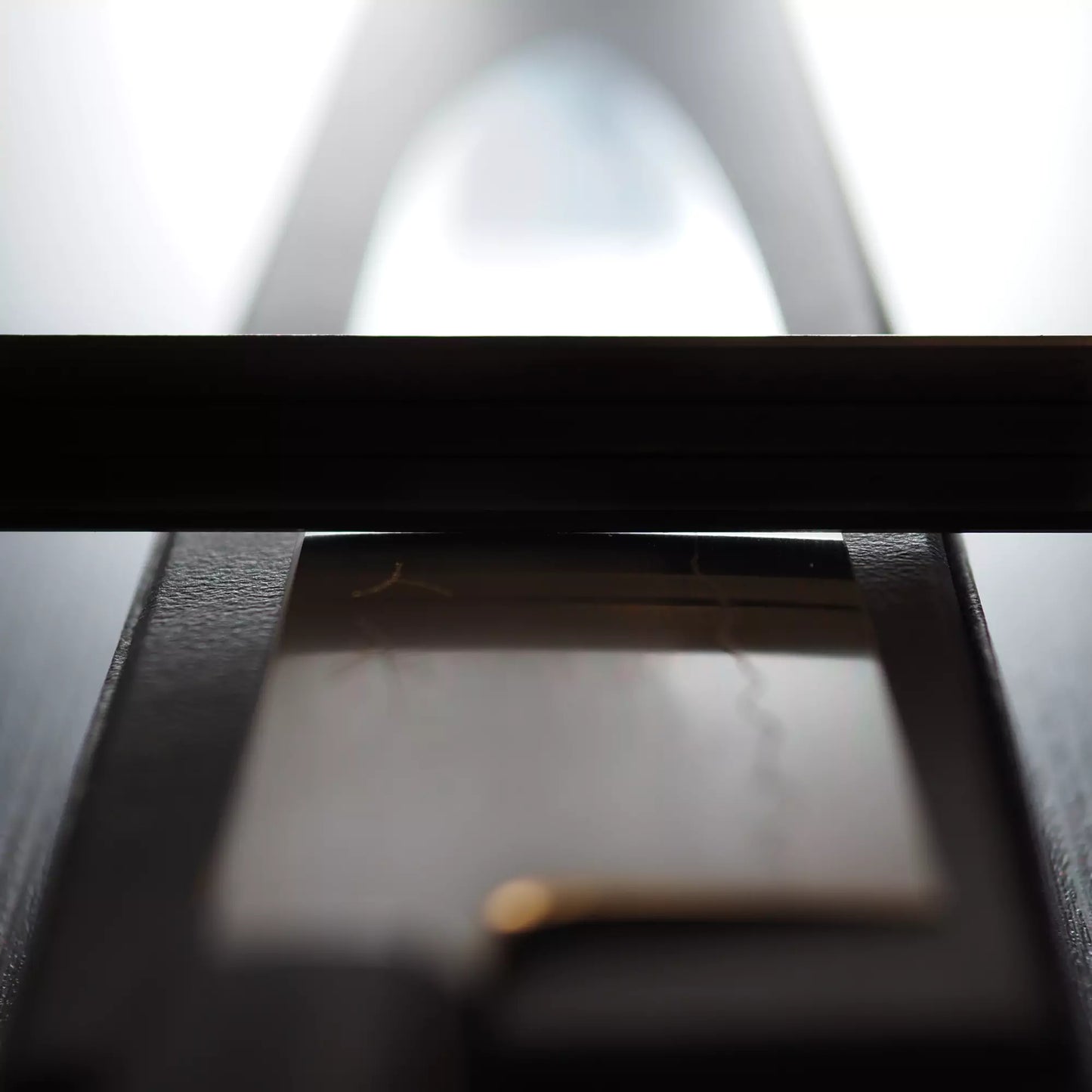 Close-up of a violin bow on a rectangular rosin block, softly lit with a blurred background, highlighting the rosin’s surface—much like how a Tetsujin kasumi ginsan gyuto 210mm gleams under kitchen lights.
