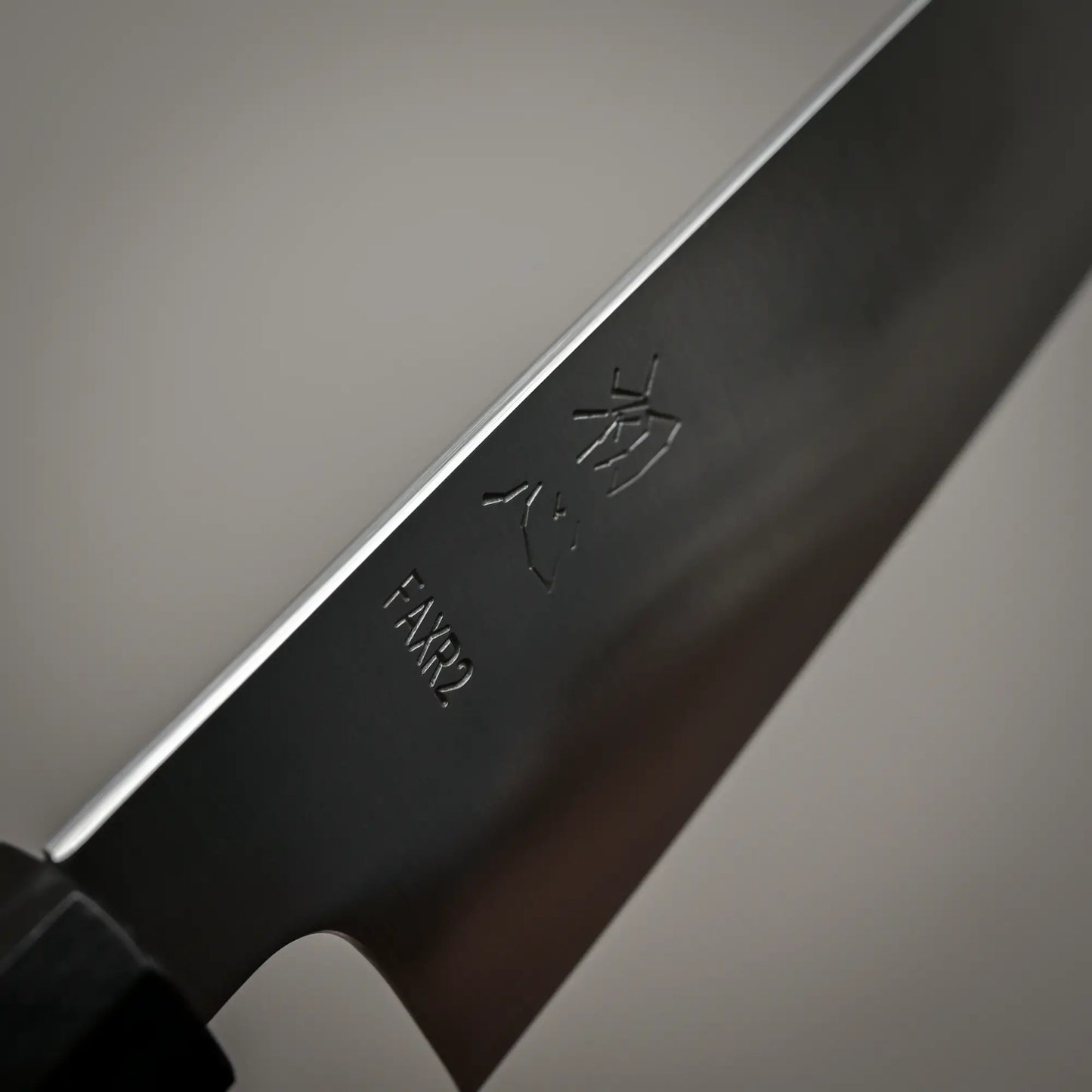 Close-up view of the spine of 210mm Hatsukokoro FAXR2 gyuto knife