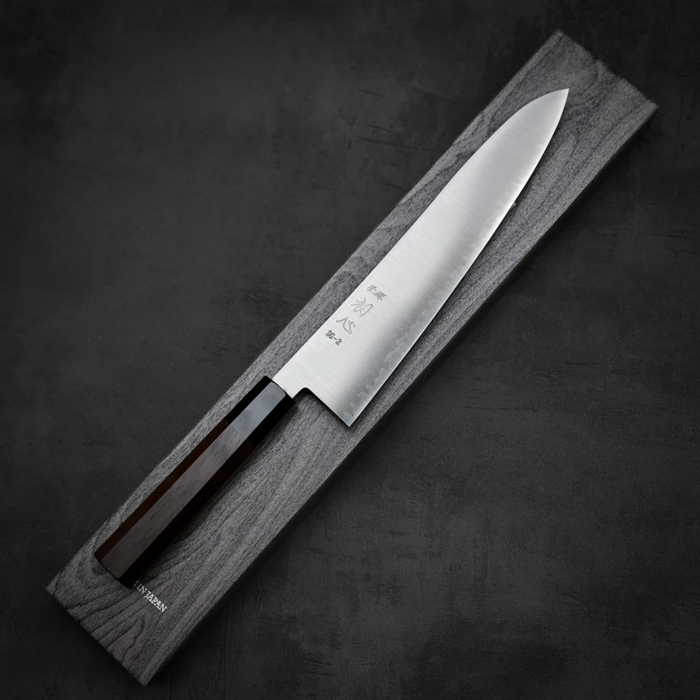 Top down view of Hatsukokoro Hayabusa SG2 gyuto knife with its box