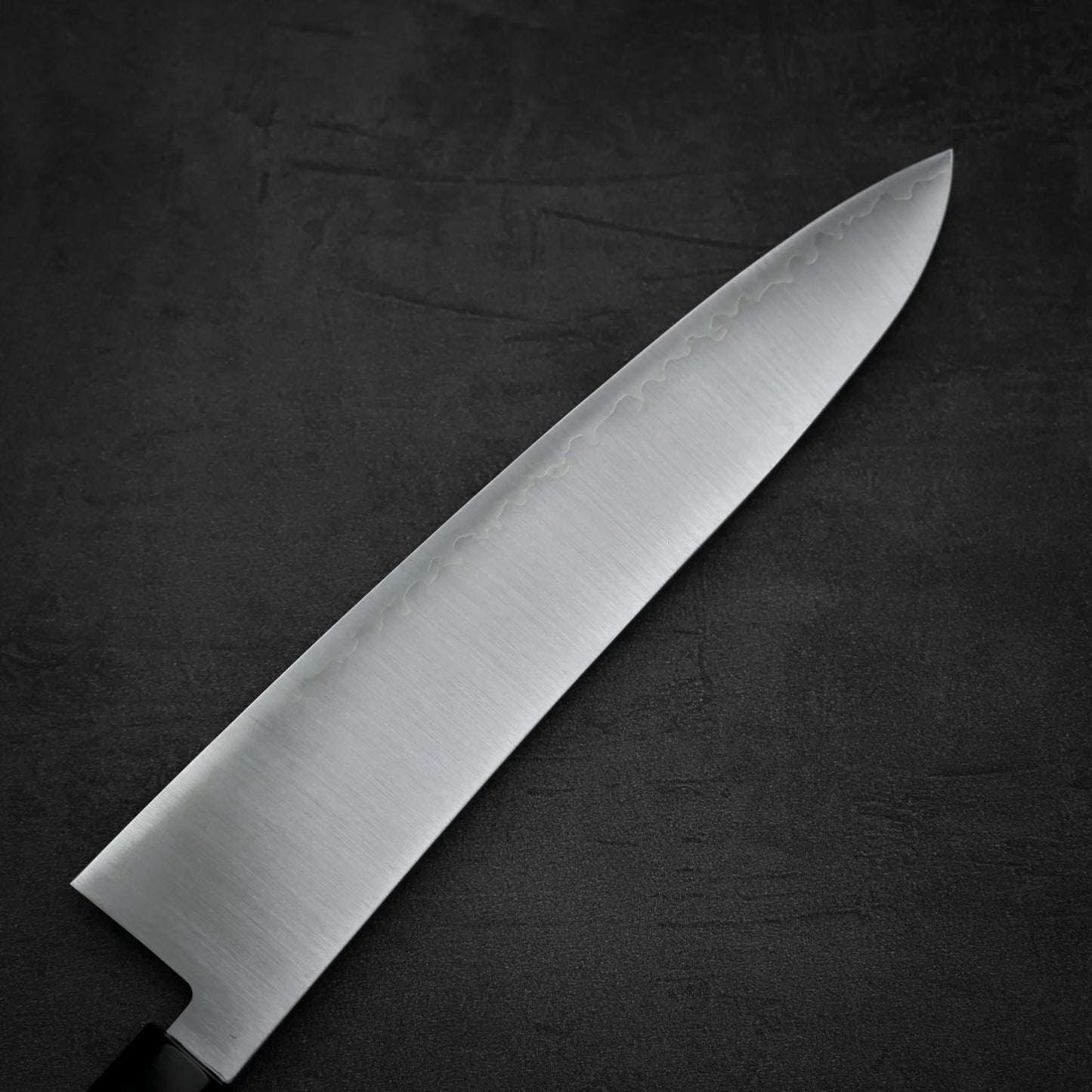 Close up view of the back side of Hatsukokoro Hayabusa SG2 gyuto knife