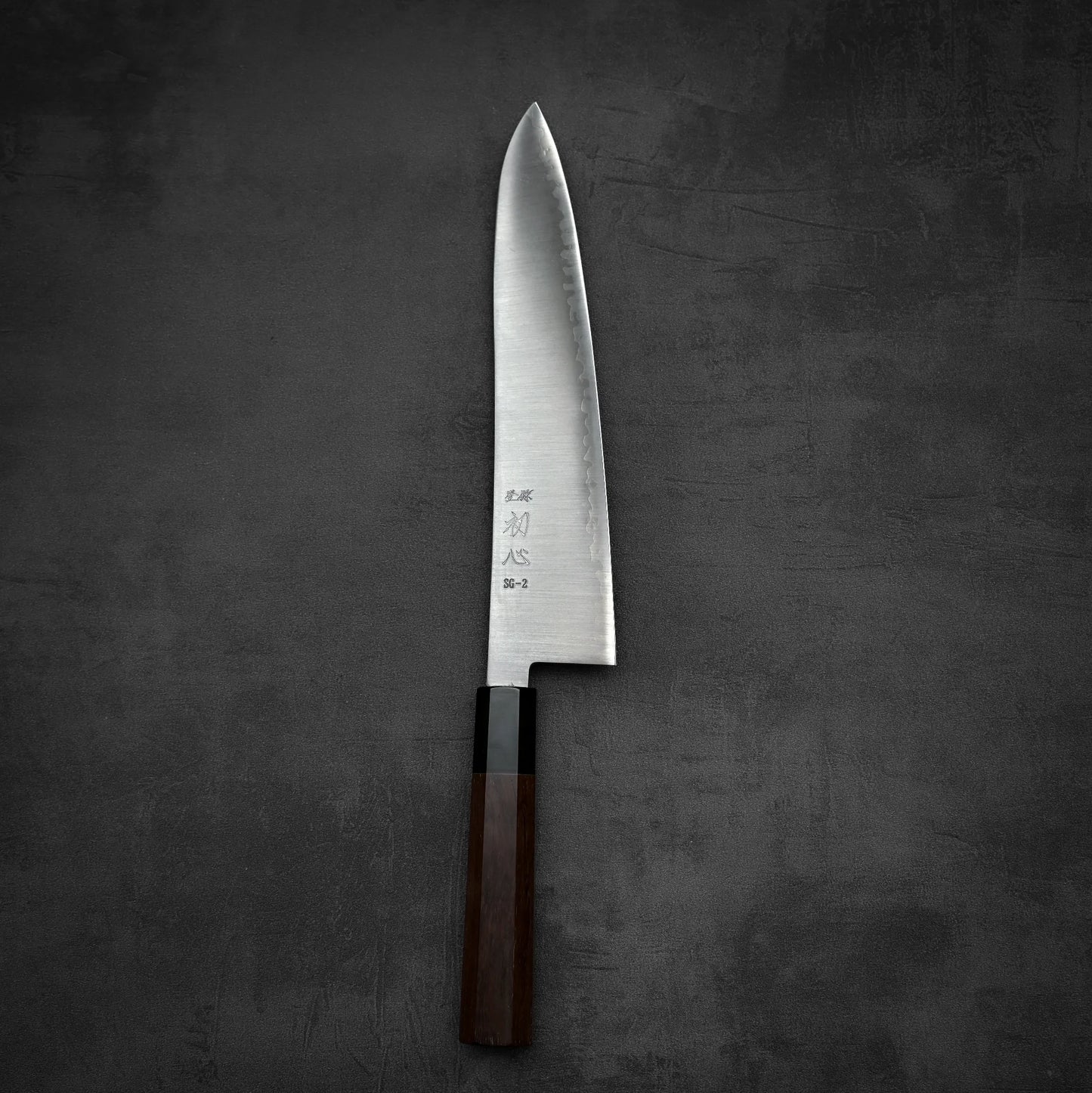 Top down view of Hatsukokoro Hayabusa SG2 gyuto knife in vertical position