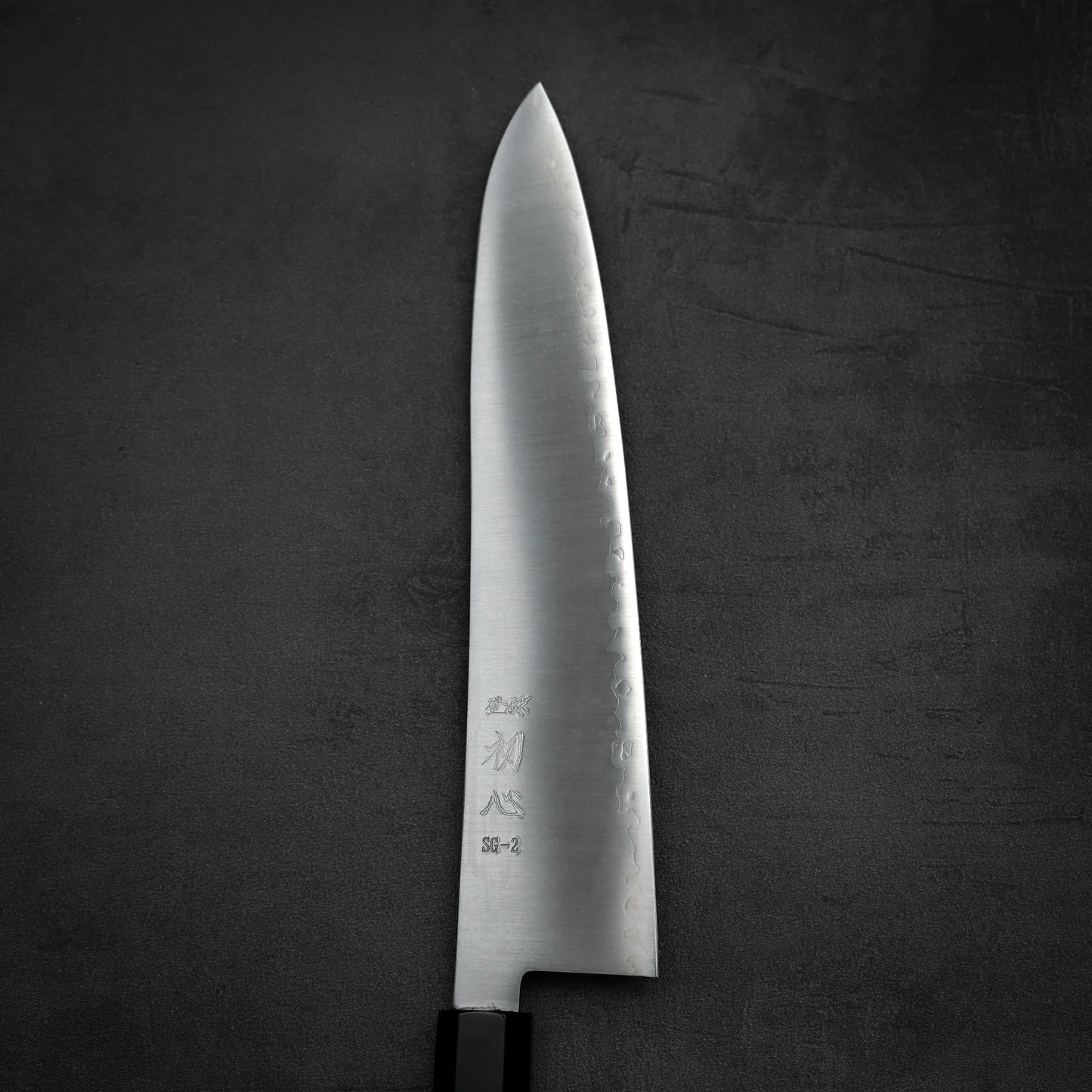 Close up view of the front blade of Hatsukokoro Hayabusa SG2 gyuto knife in vertical position