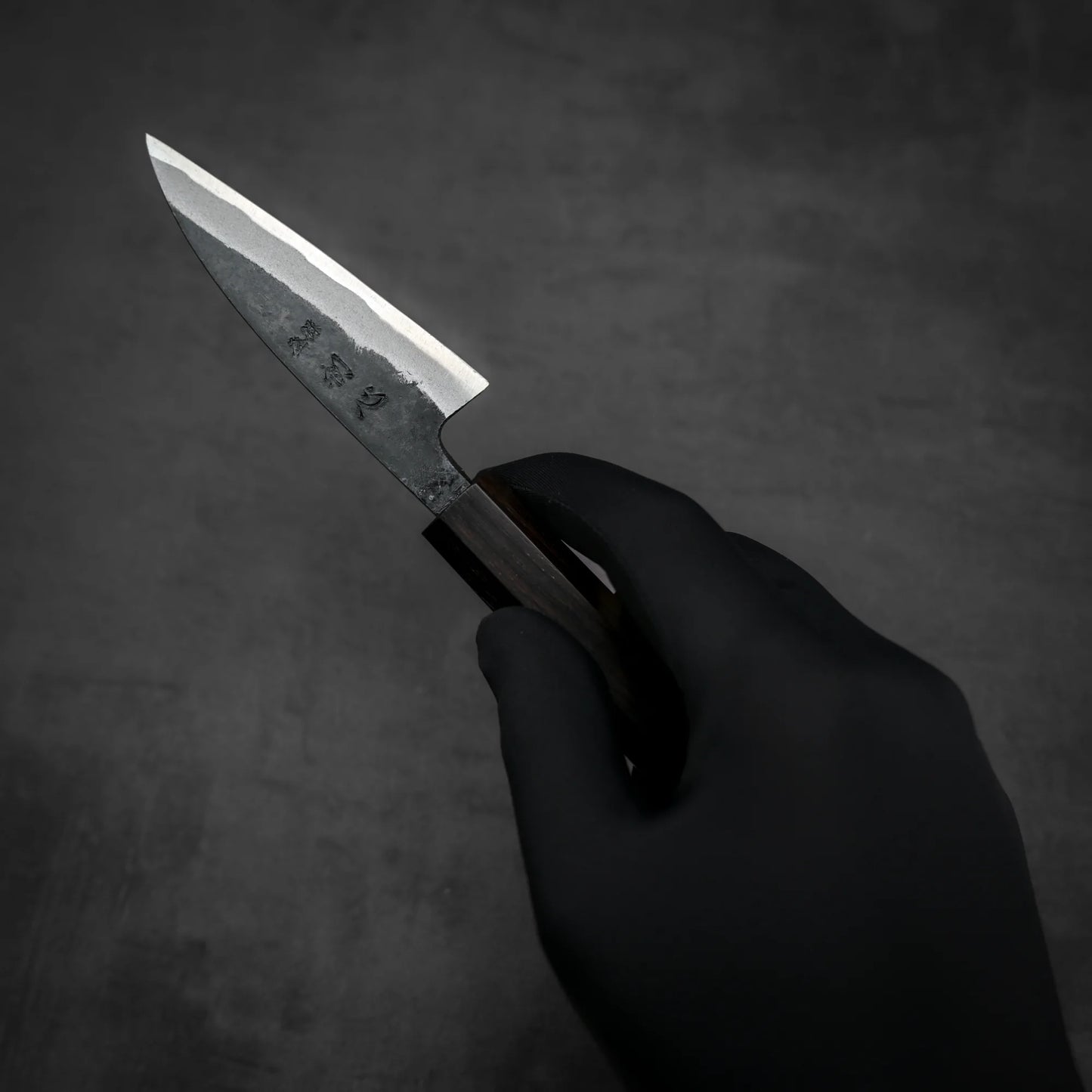 Top down view of Hatsukokoro kurouchi aogami#2 petty knife held in hand
