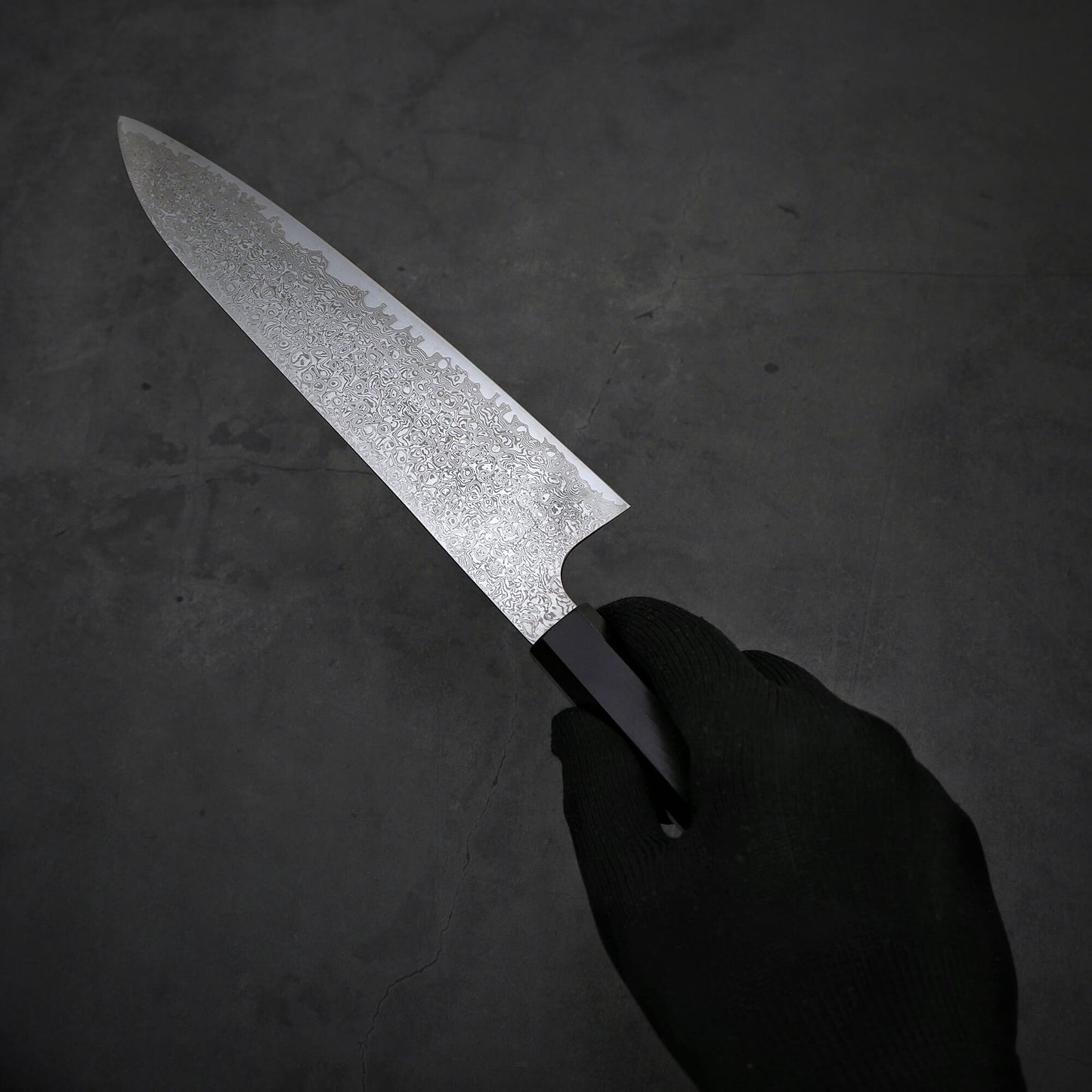 Hand holding Hatsukokoro ginsan damascus gyuto 210mm