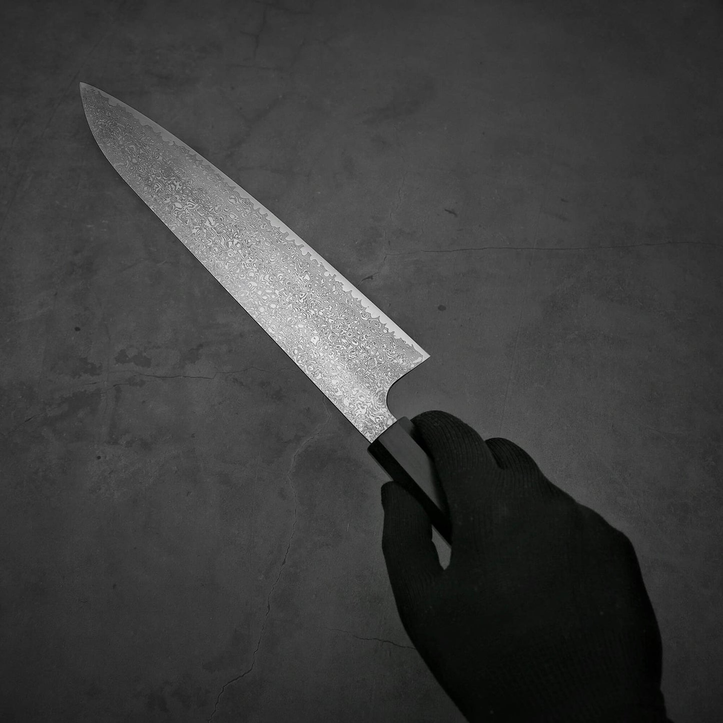 Hand holding Hatsukokoro ginsan damascus gyuto 240mm