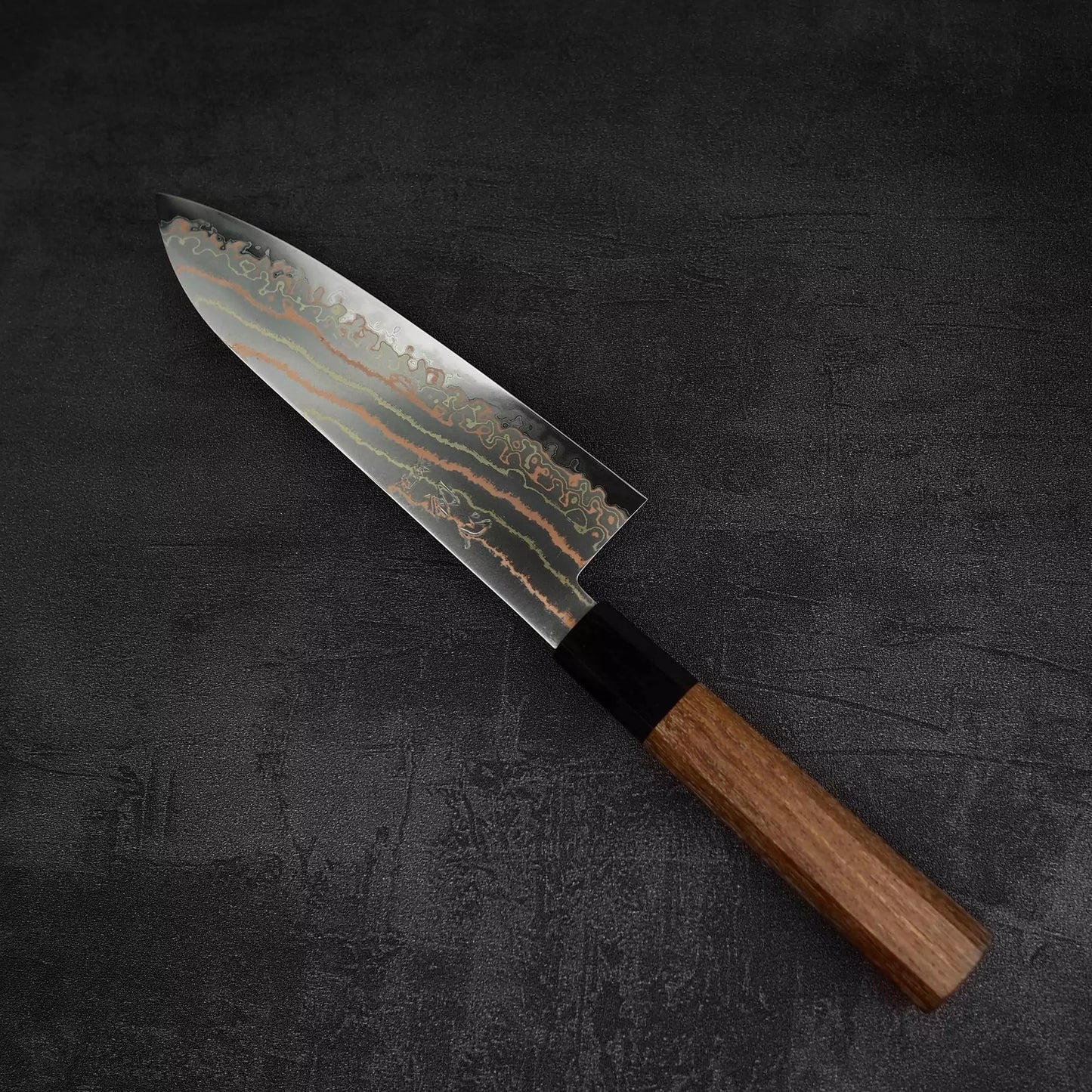 Top down view of Hatsukokoro Habayusa aogami#2 rainbow damascus santoku knife