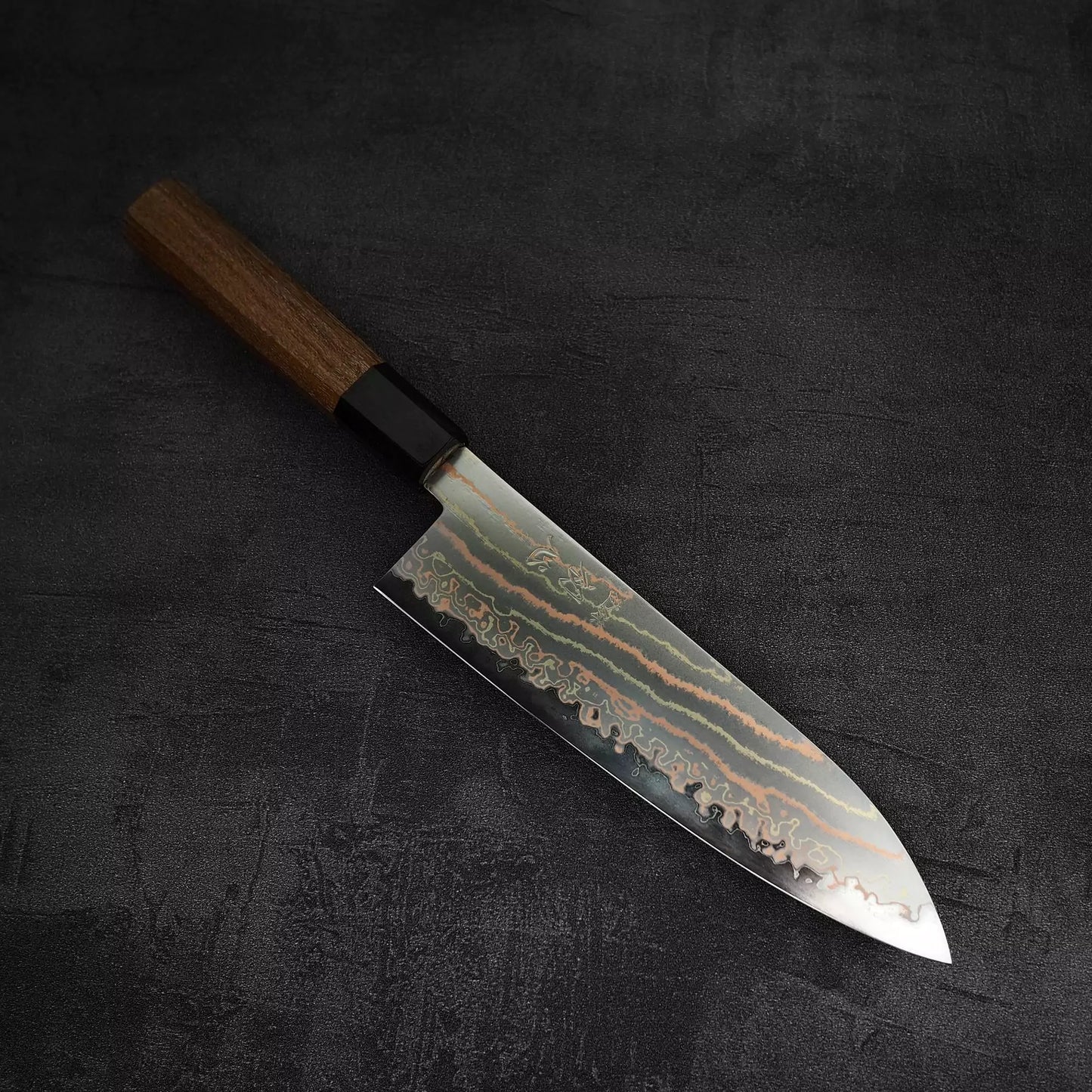 Angled view of Hatsukokoro Habayusa aogami#2 rainbow damascus santoku knife