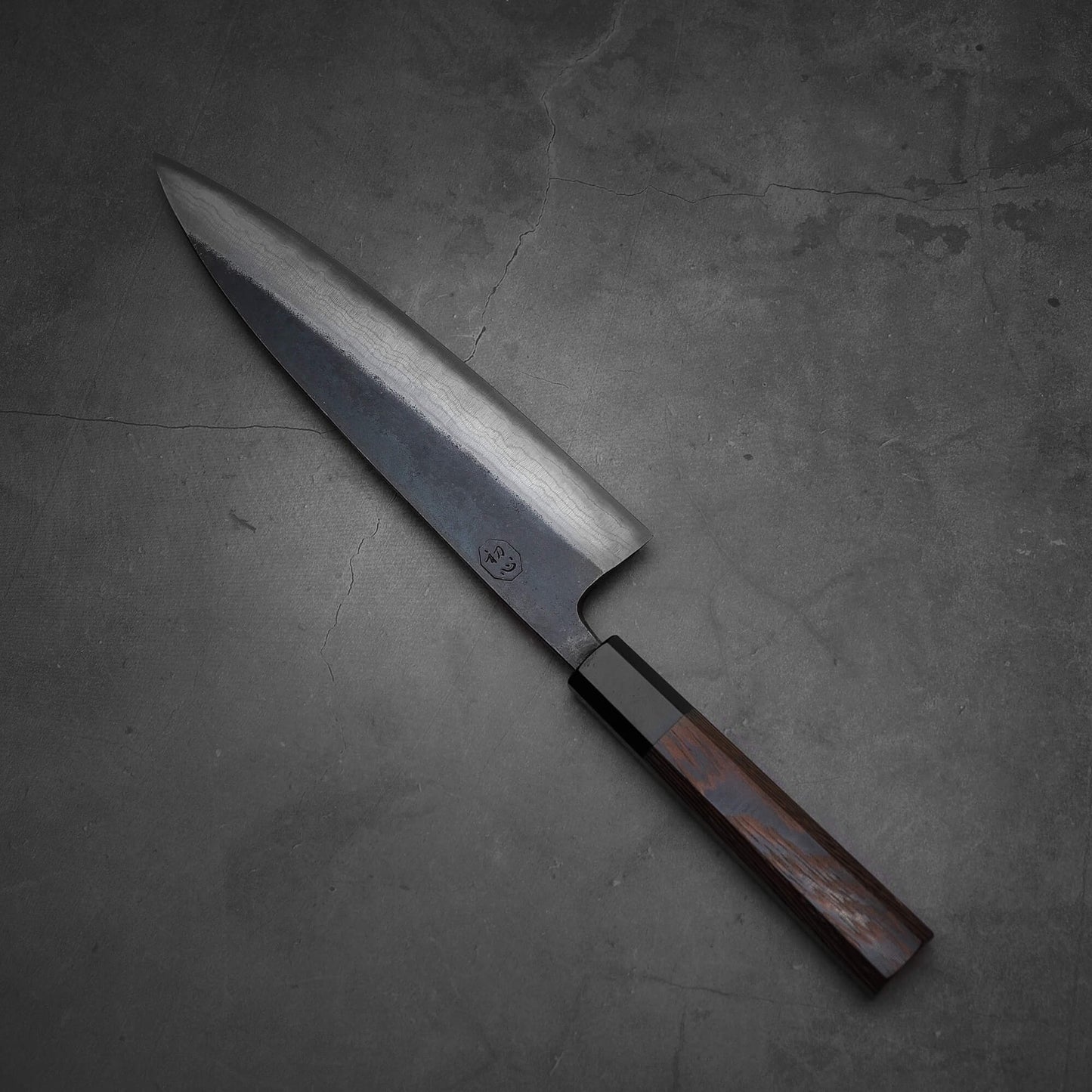 Top view of Hatsukokoro Kumokage gyuto knife where tip is facing upper left