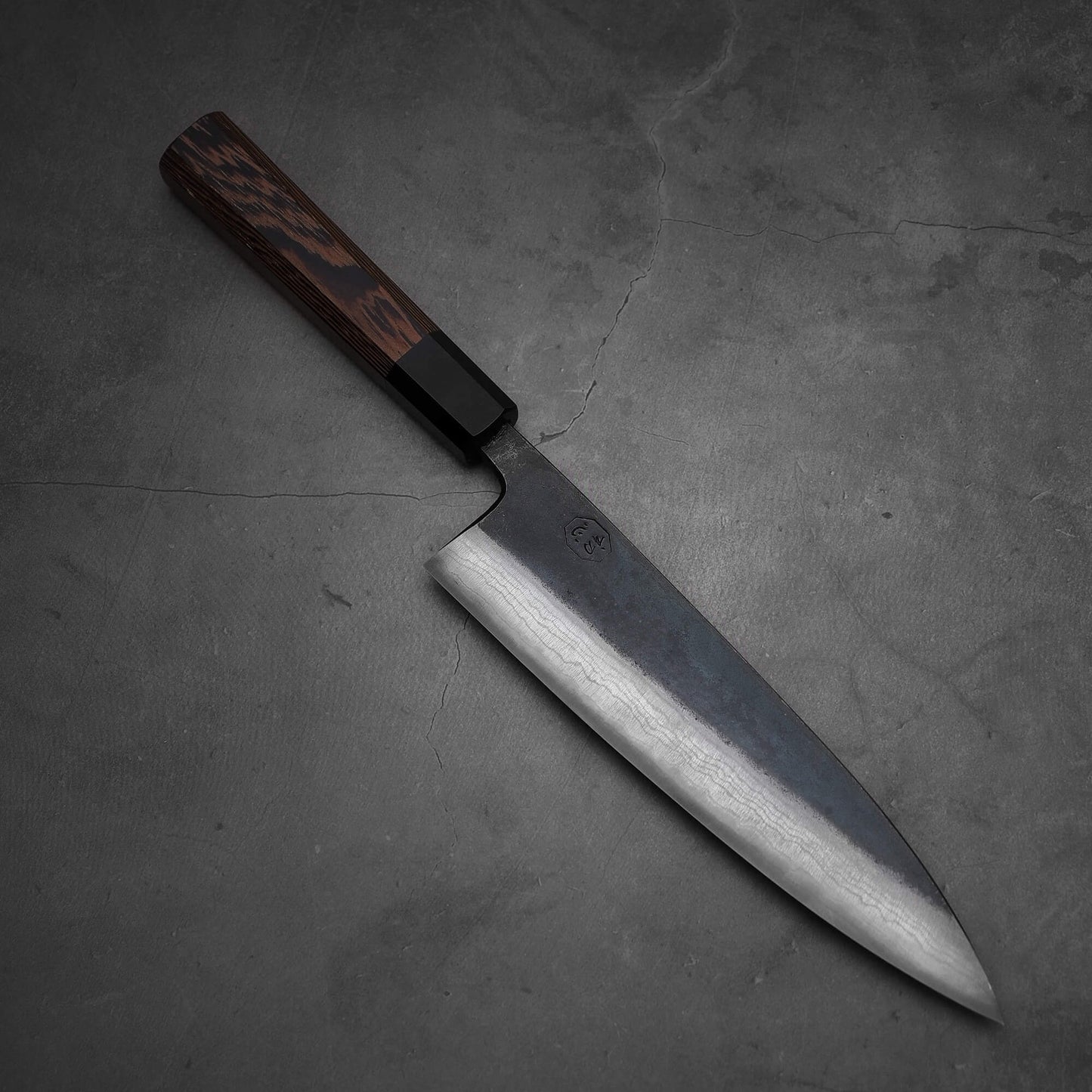 Top view of Hatsukokoro Kumokage gyuto knife where tip is facing the lower right