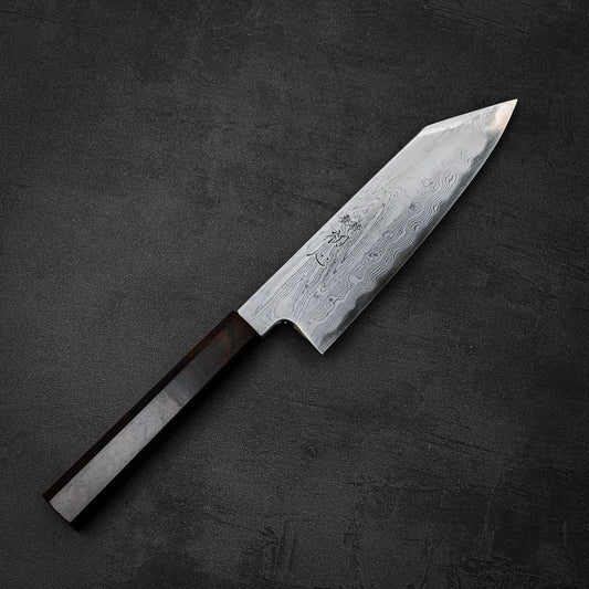 The Satoshi Nakagawa Nakagawa aogami#1 damascus bunka 180mm knife, with its patterned blade and dark wooden handle, is displayed on a textured dark gray surface.