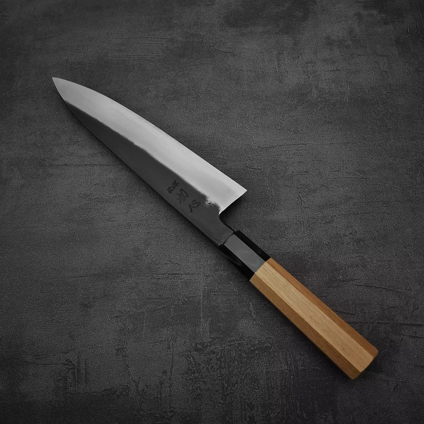 Angled view of Hatsukokoro Yoake kurouchi aogami#1 gyuto