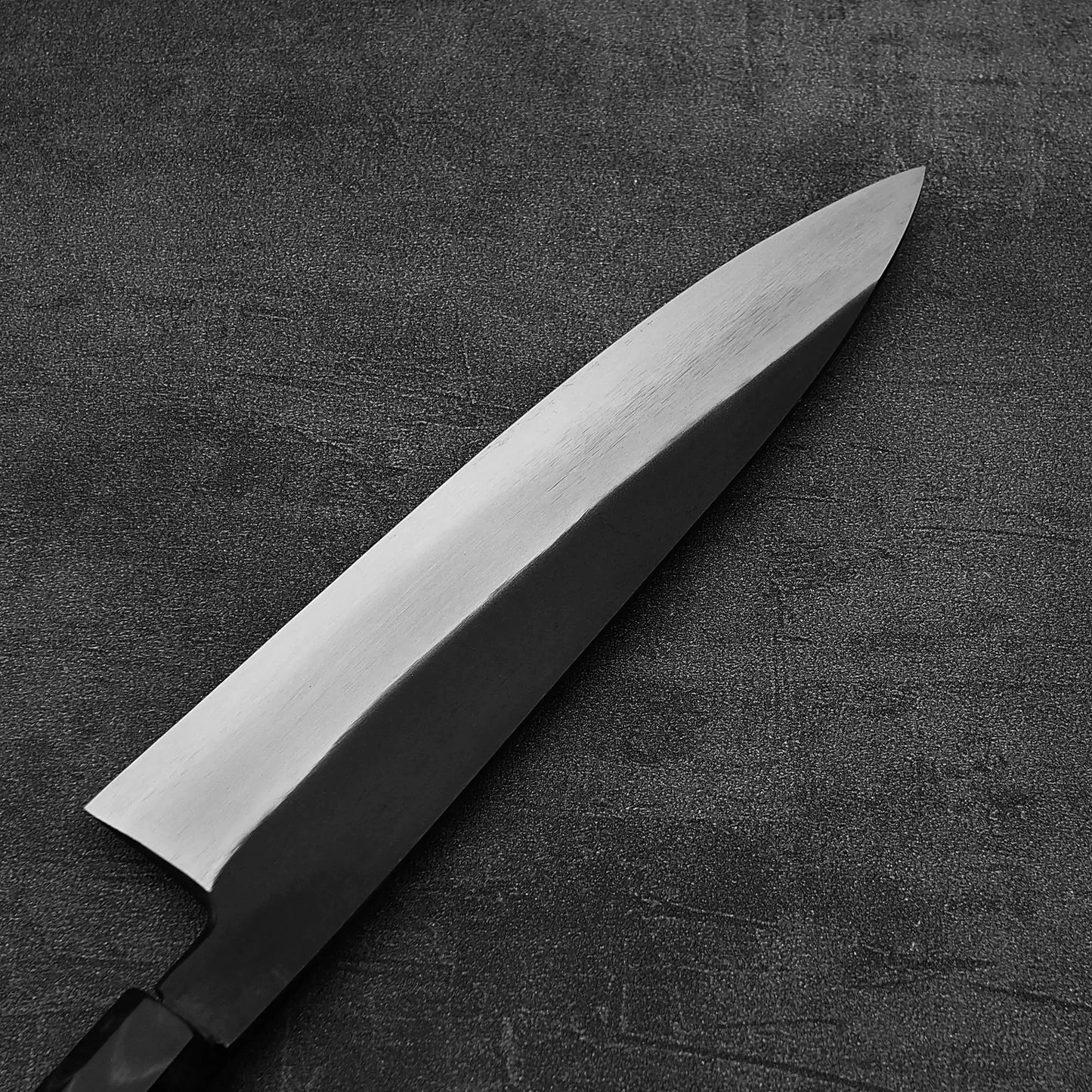 Close up view of the back side of Hatsukokoro Yoake kurouchi aogami#1 gyuto