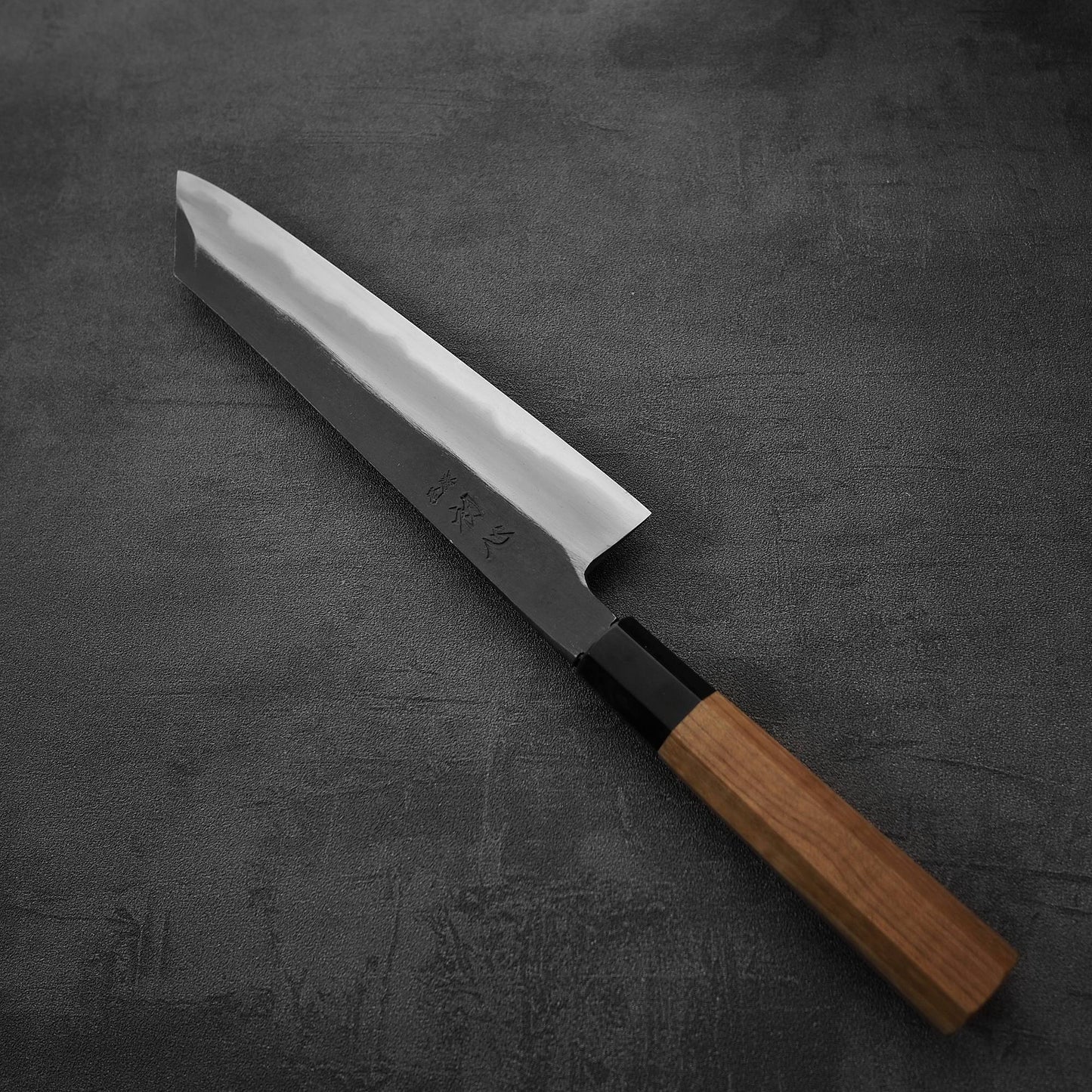 Angled view of Hatsukokoro Yoake kurouchi aogami#1 kiritsuke gyuto knife