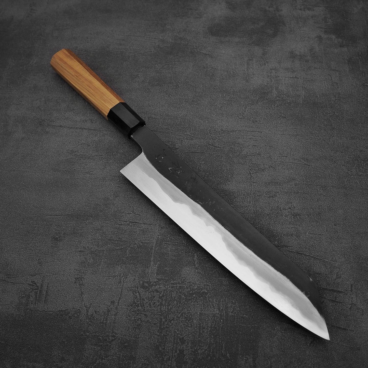 Angled view of Hatsukokoro Yoake kurouchi aogami#1 kiritsuke gyuto knife
