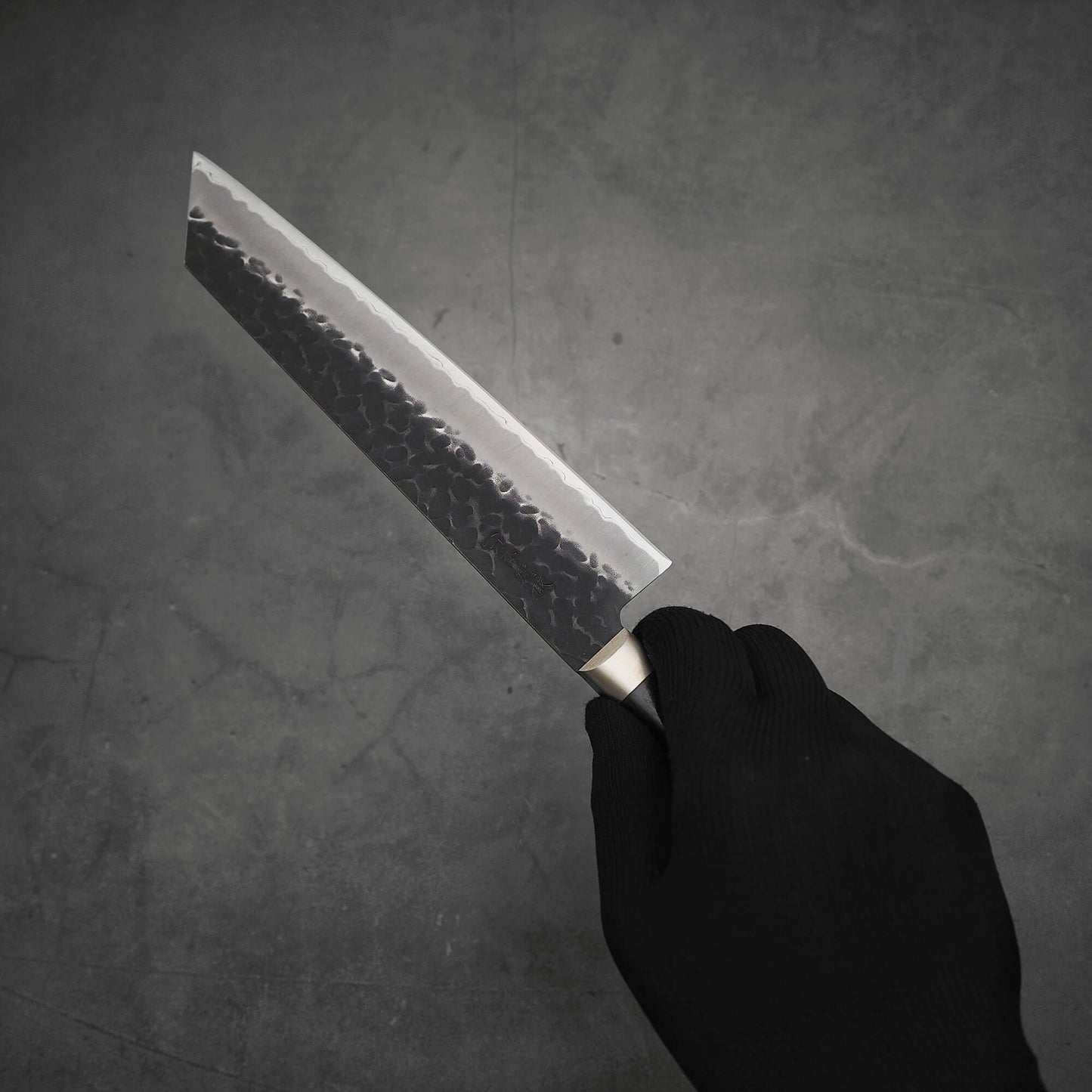 Hand holding Ittosai Kotetsu tsuchime kurouchi aogami super kiritsuke gyuto