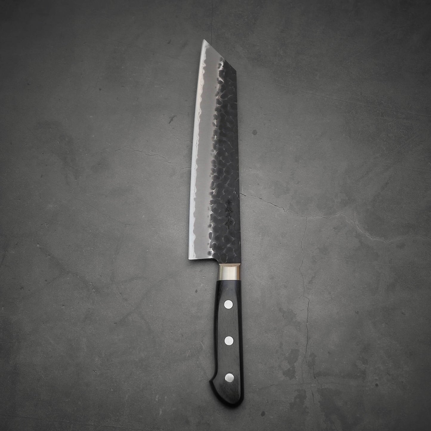 Top view of Ittosai Kotetsu tsuchime kurouchi aogami super kiritsuke gyuto showing the back side of the knife
