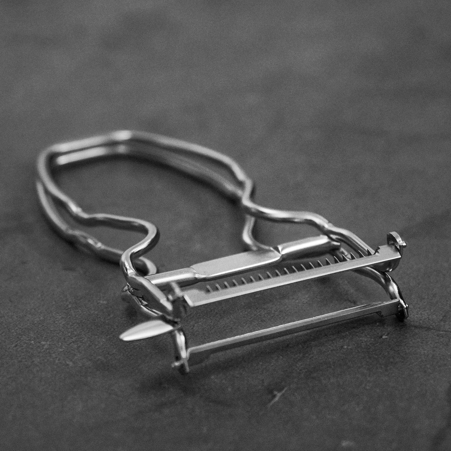 Angled view of Kankuma Tsuma and Peeler: A versatile Japanese kitchen tool for peeling and creating tsuma cuts. Made in Japan.