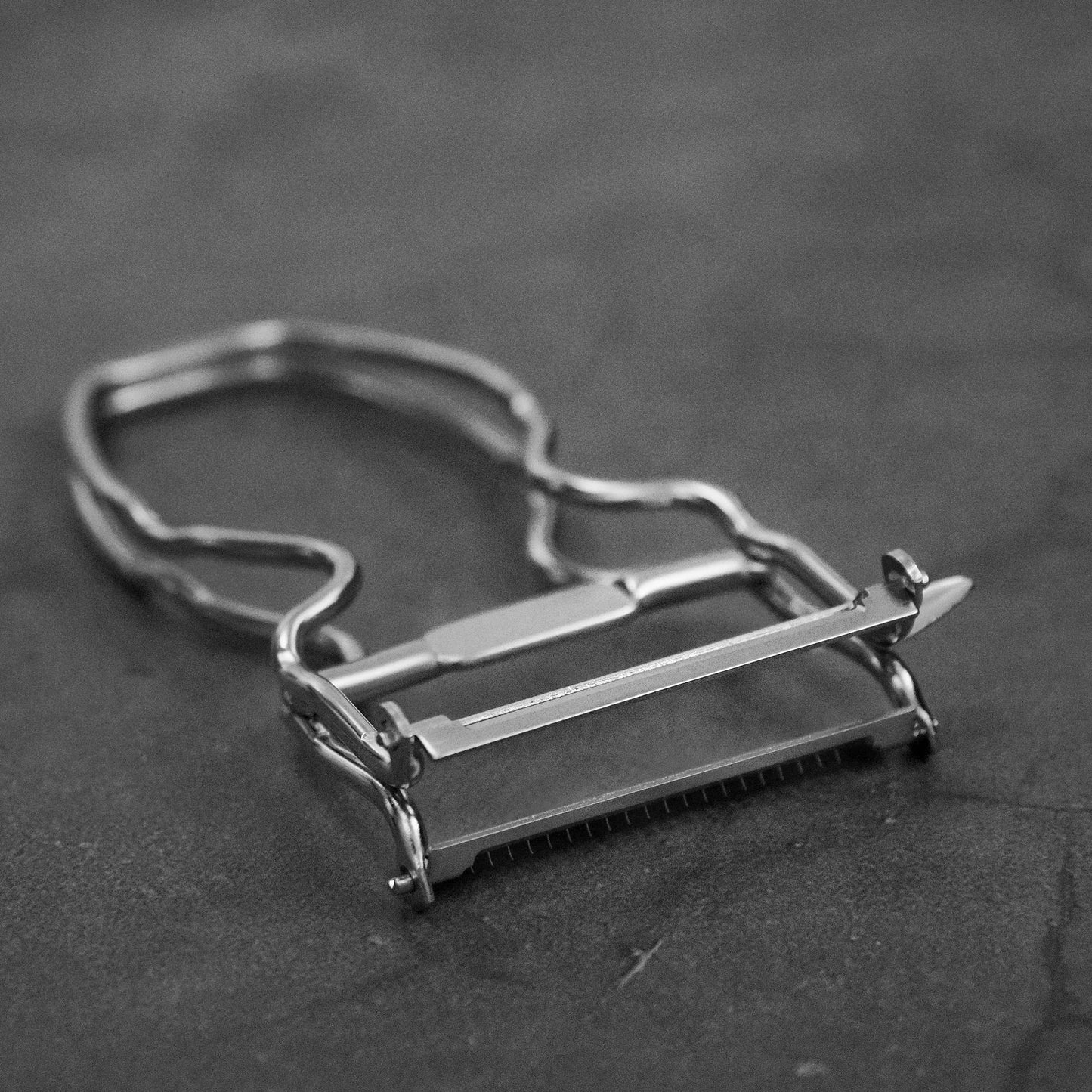 Angled view of Kankuma Tsuma and Peeler: A versatile Japanese kitchen tool for peeling and creating tsuma cuts. Made in Japan.
