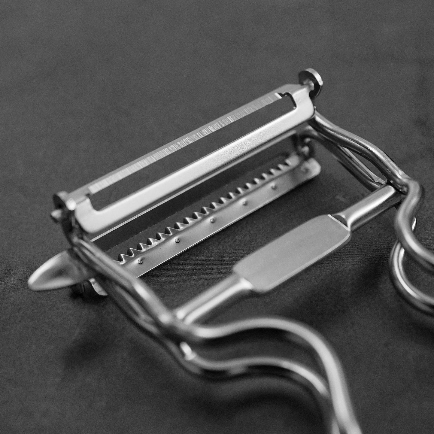 Close up view of Kankuma Tsuma and Peeler: A versatile Japanese kitchen tool for peeling and creating tsuma cuts. Made in Japan.