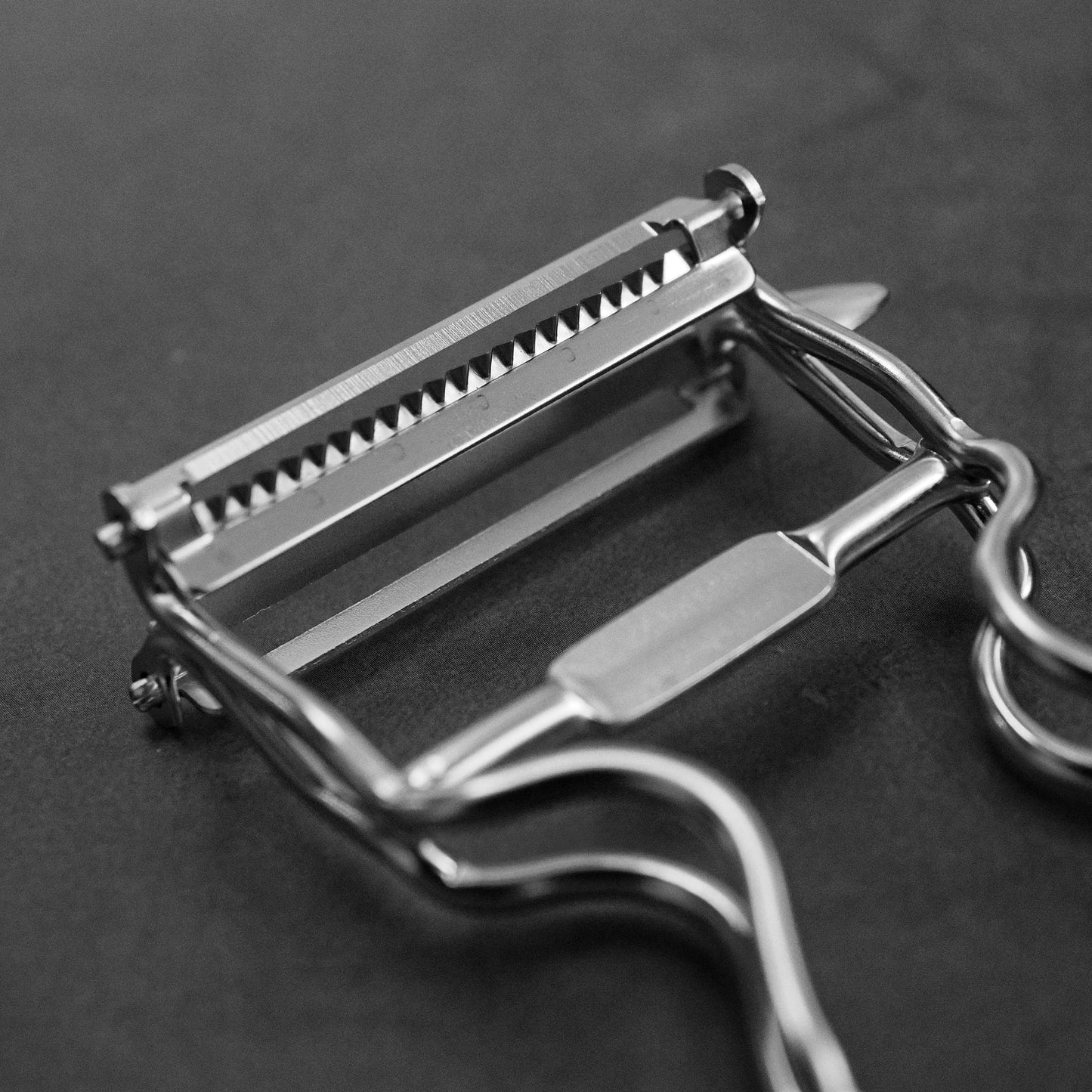 Close up view of Kankuma Tsuma and Peeler: A versatile Japanese kitchen tool for peeling and creating tsuma cuts. Made in Japan.