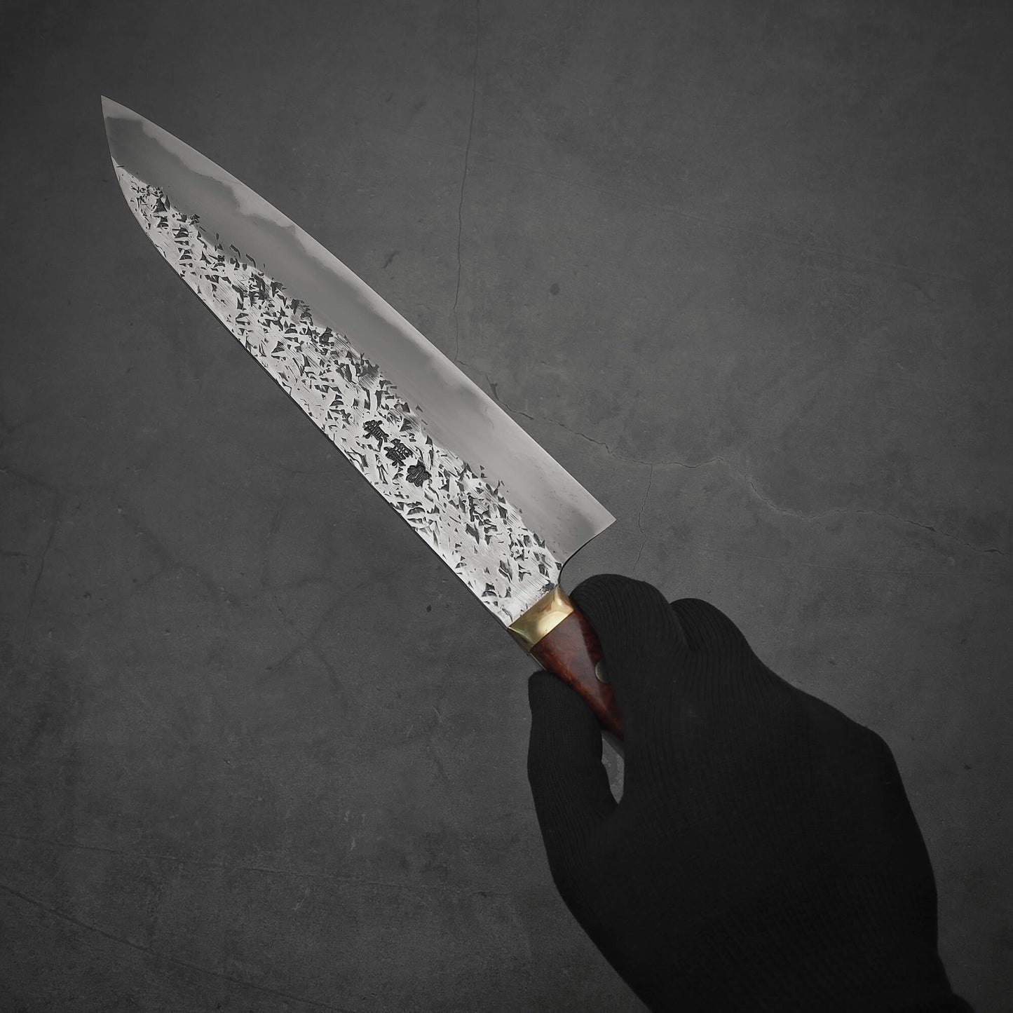Hand holding 240mm Kisuke Manaka tsuchime honwarikomi shirogami#2 gyuto knife