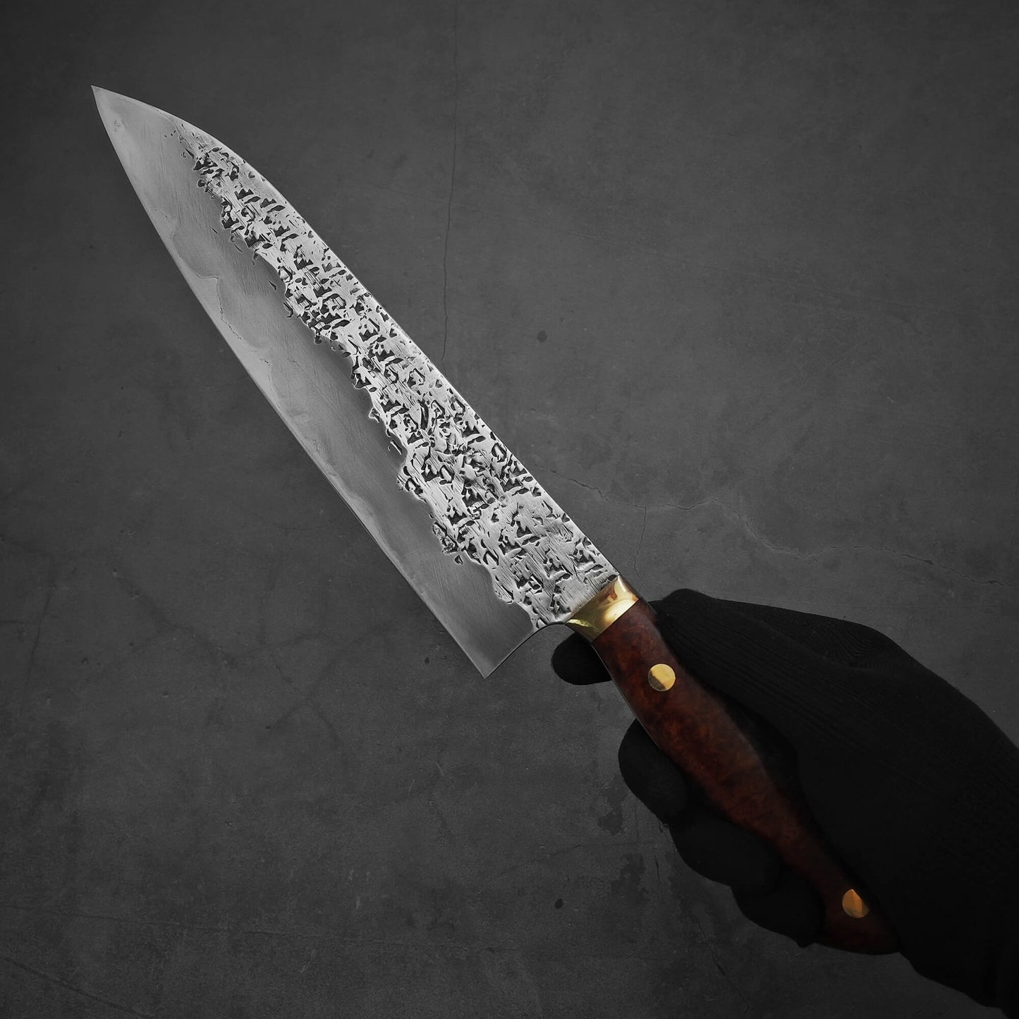Hand holding 240mm Kisuke Manaka tsuchime honwarikomi shirogami#2 gyuto knife showing the left side of the blade