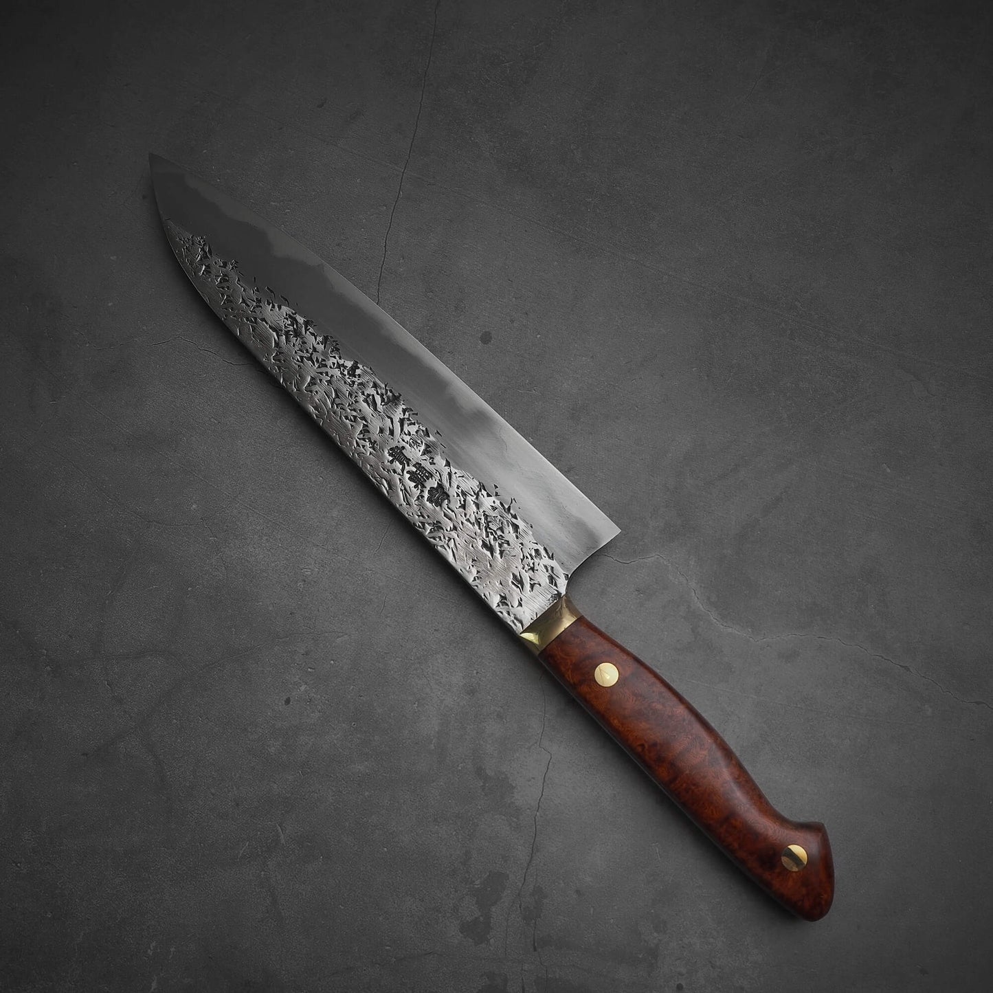 Top view of 240mm Kisuke Manaka tsuchime honwarikomi shirogami#2 gyuto knife where the tip faces the upper left