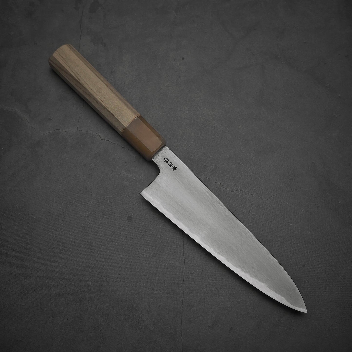 Top view of Nakagawa aogami#2 gyuto knife where the pointed tip is facing towards the lower right.