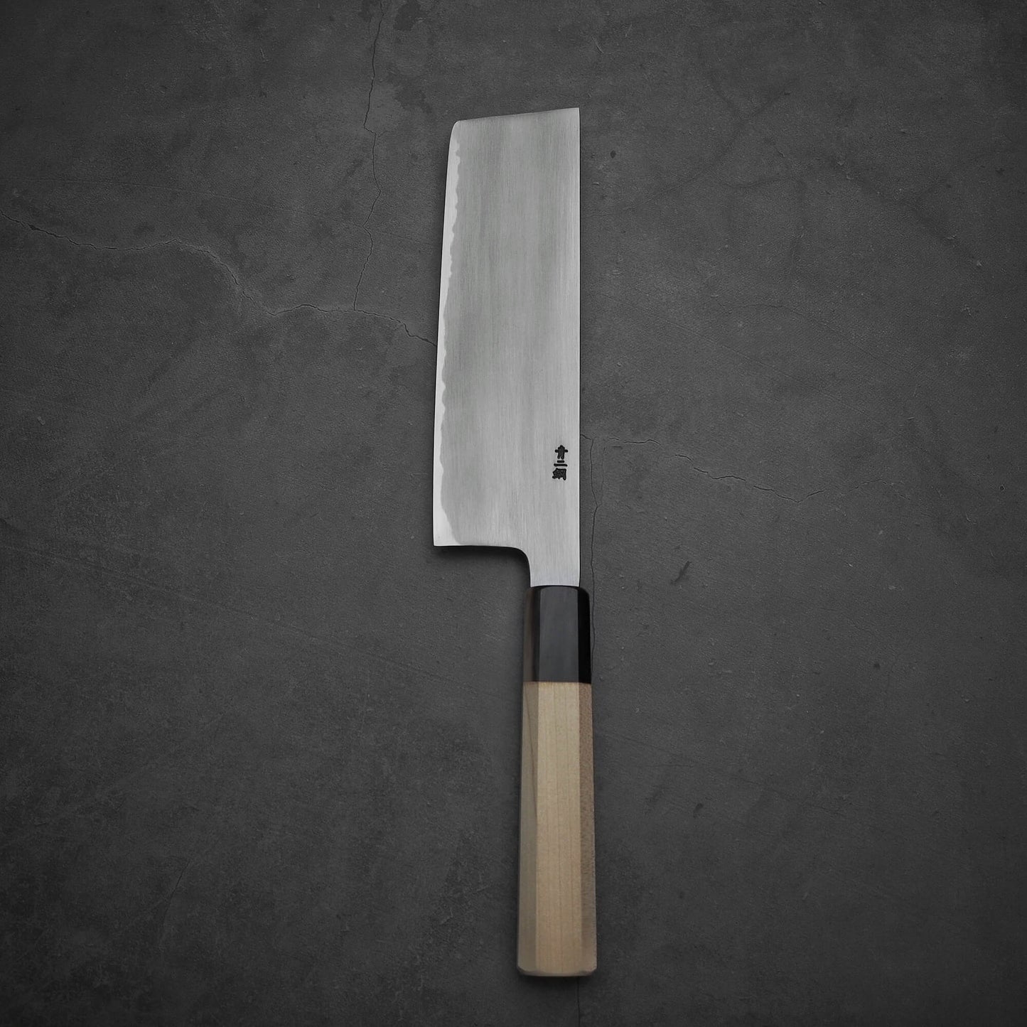 Top view of Nakagawa aogami#2 nakiri knife in vertical position. Image shows the back side