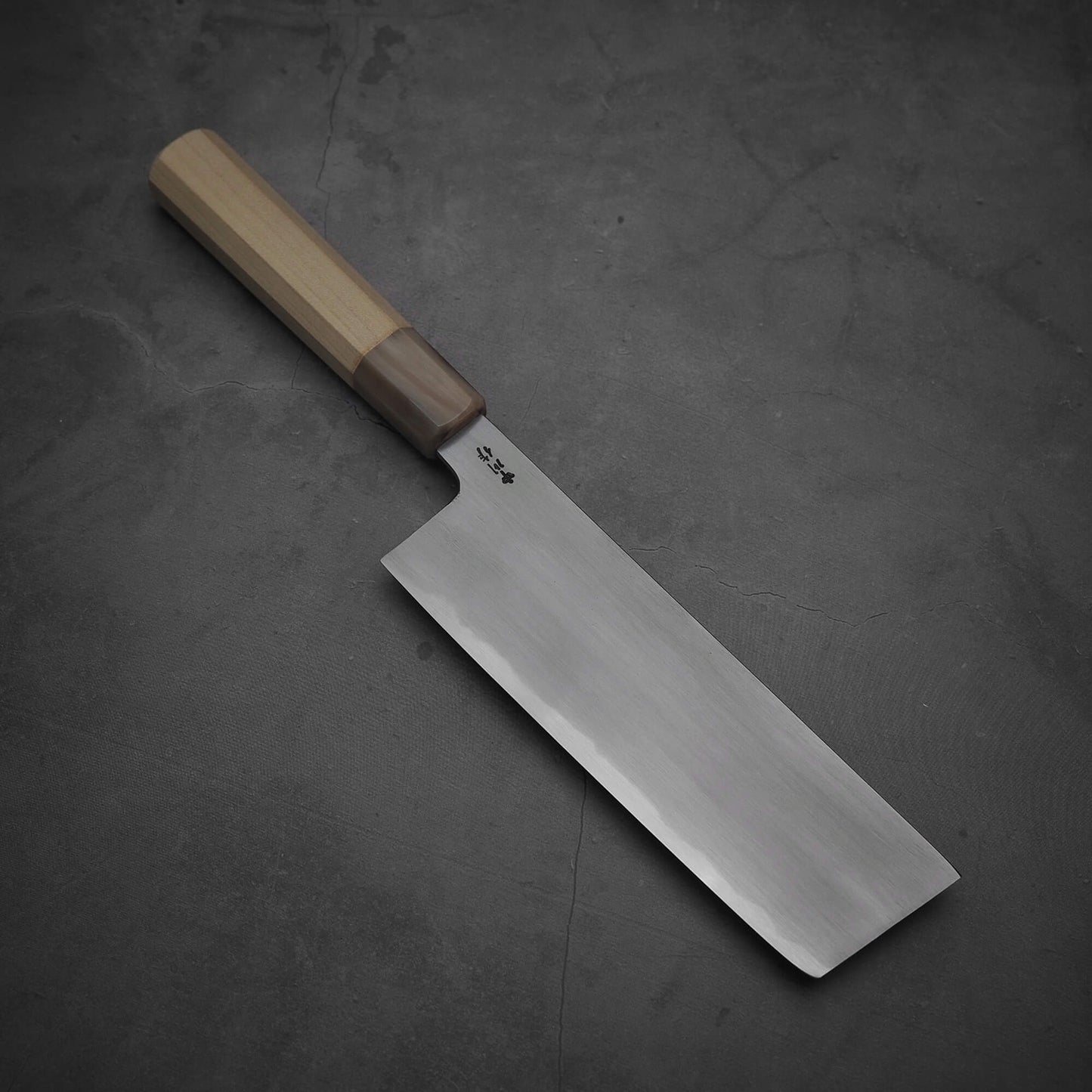 Top view of Nakagawa aogami#2 nakiri knife where the tip area is facing towards lower right.