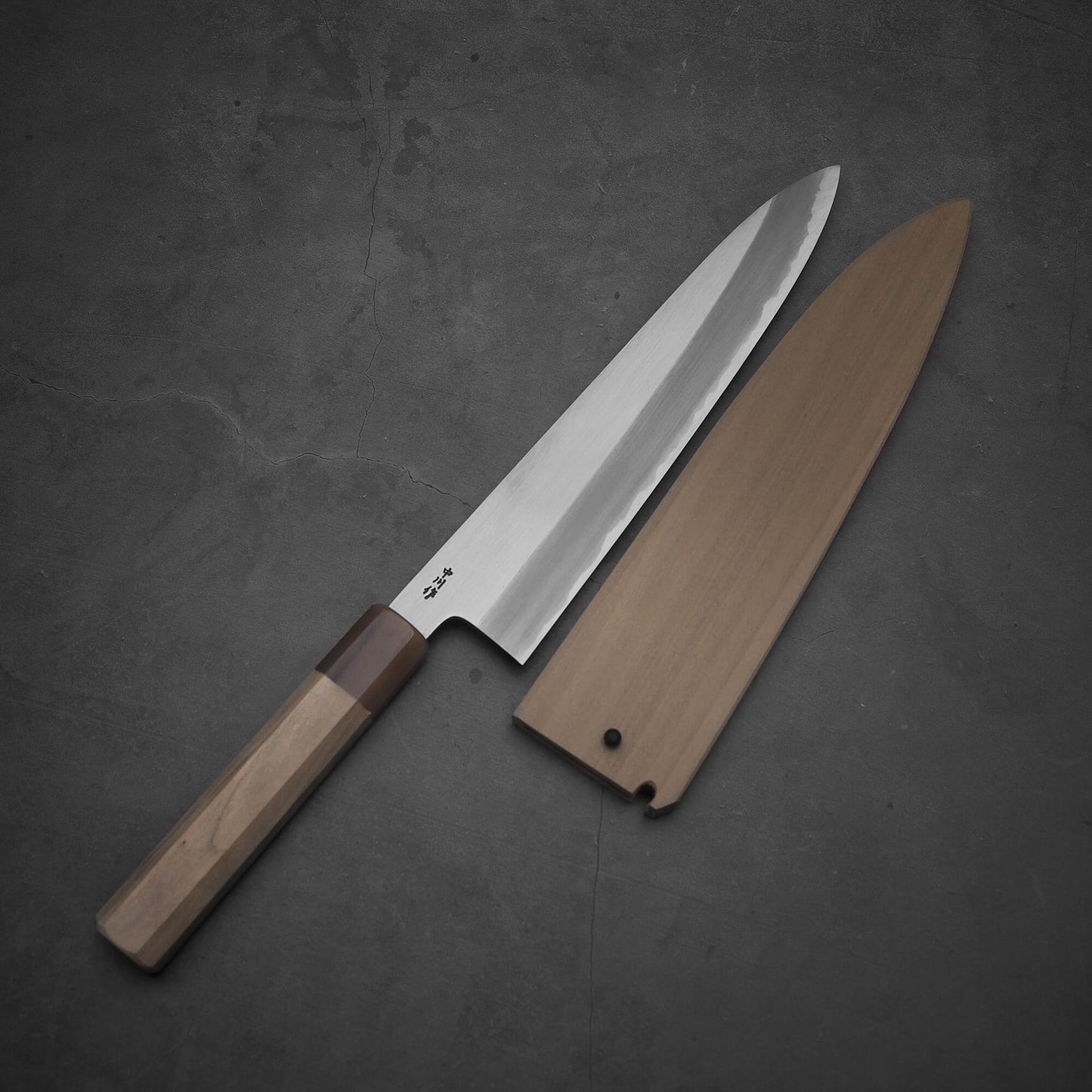 Top view of Nakagawa shinogi aogami#2 gyuto knife with its magnolia saya