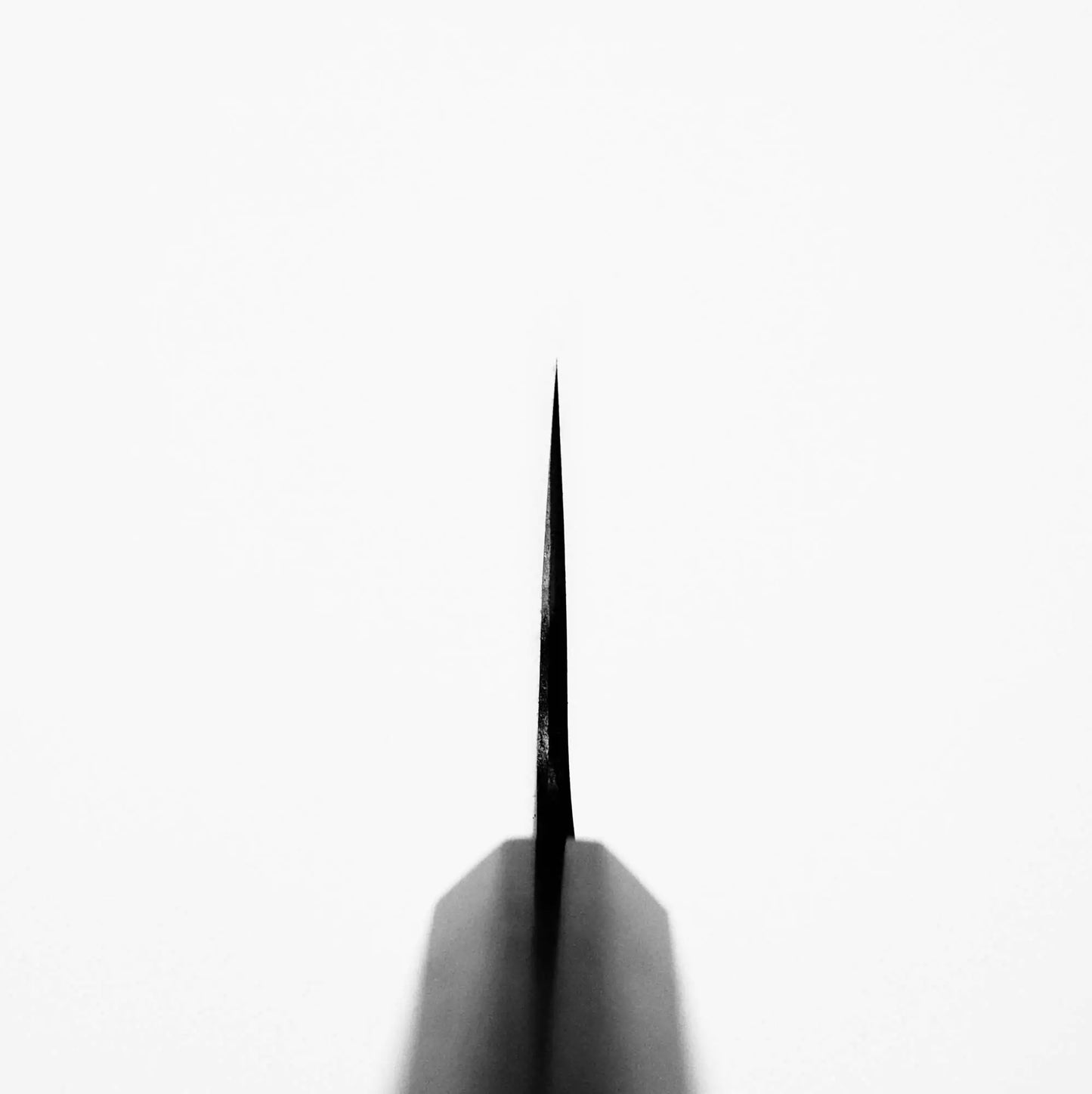 A Nao Yamamoto kurouchi aogami#2 nakiri 180mm knife blade by Nao Yamamoto, photographed from above on a white background, lies vertically centered with a symmetrical silhouette and subtle shadow, highlighting its edge retention.