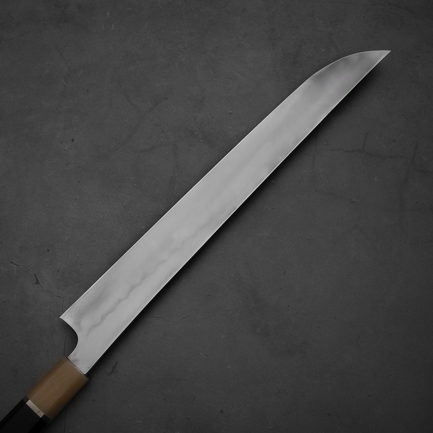 Top down view of the back side of Nigara honyaki sakimaru forged by Tsuyoshi Yoshizawa. This honyaki is hand-forged made of aogami#2 steel.