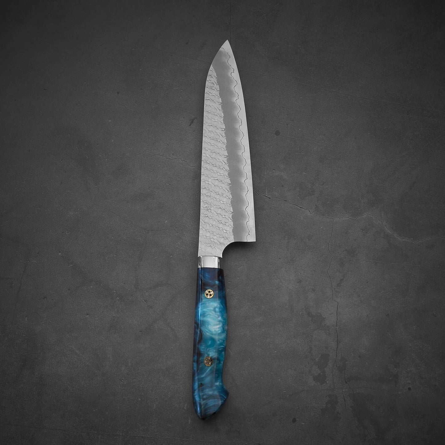 Top view of 210mm Nigara tsuchime SG2 gyuto knife with blue handle in vertical position