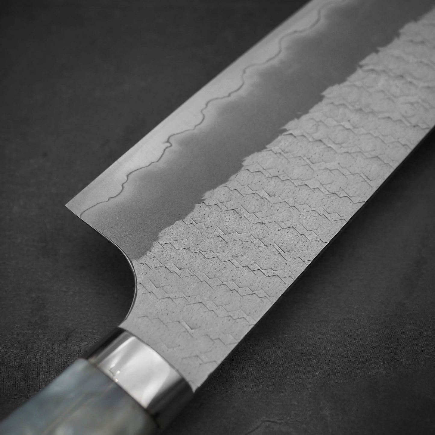 Close up view on the other side of 210mm Nigara tsuchime SG2 gyuto knife with pearl handle resin