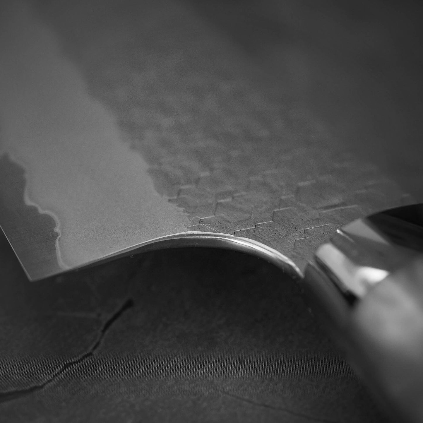 Close up view of the choil of 210mm Nigara tsuchime SG2 gyuto knife with pearl handle resin