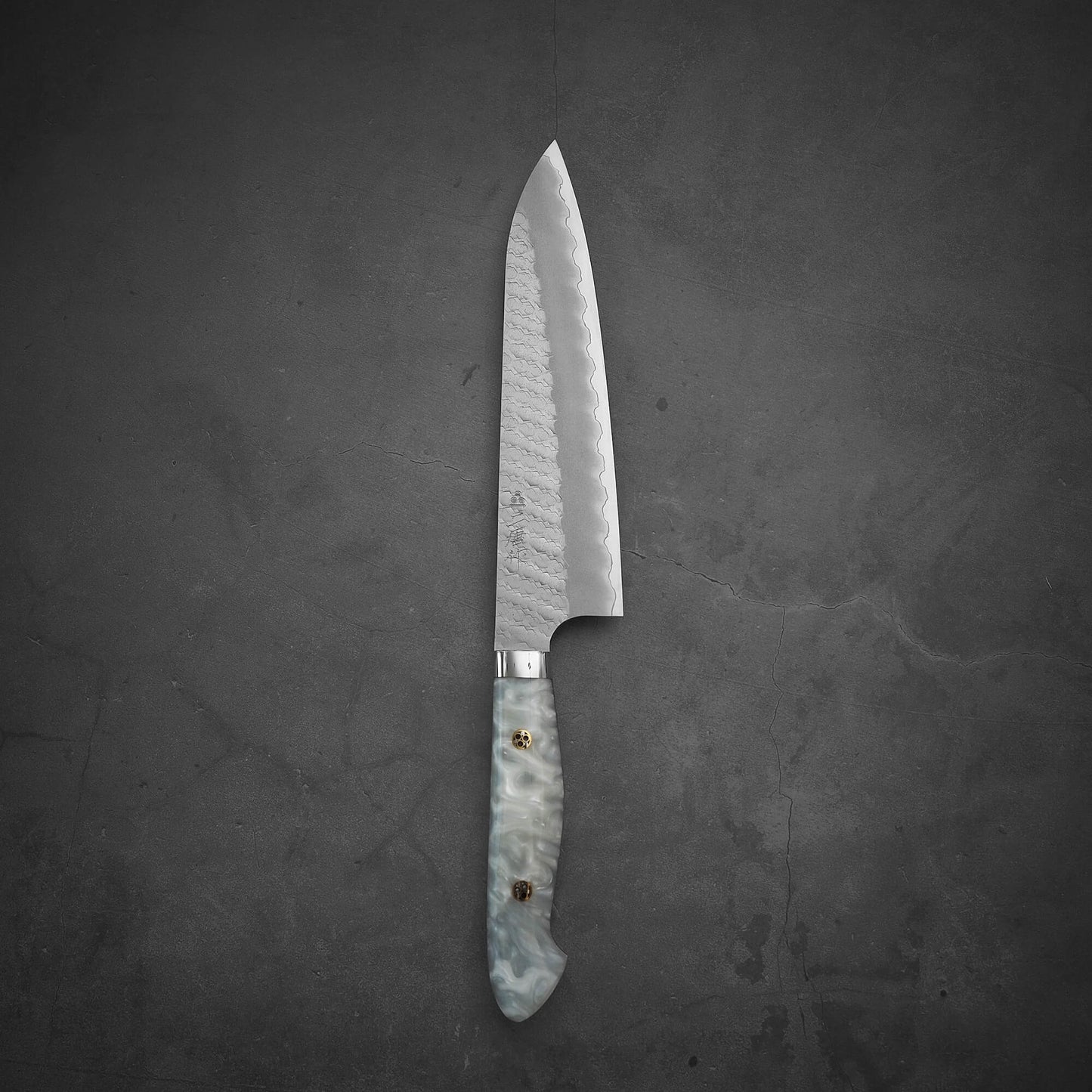 Top view of 210mm Nigara tsuchime SG2 gyuto knife with pearl handle resin in vertical position
