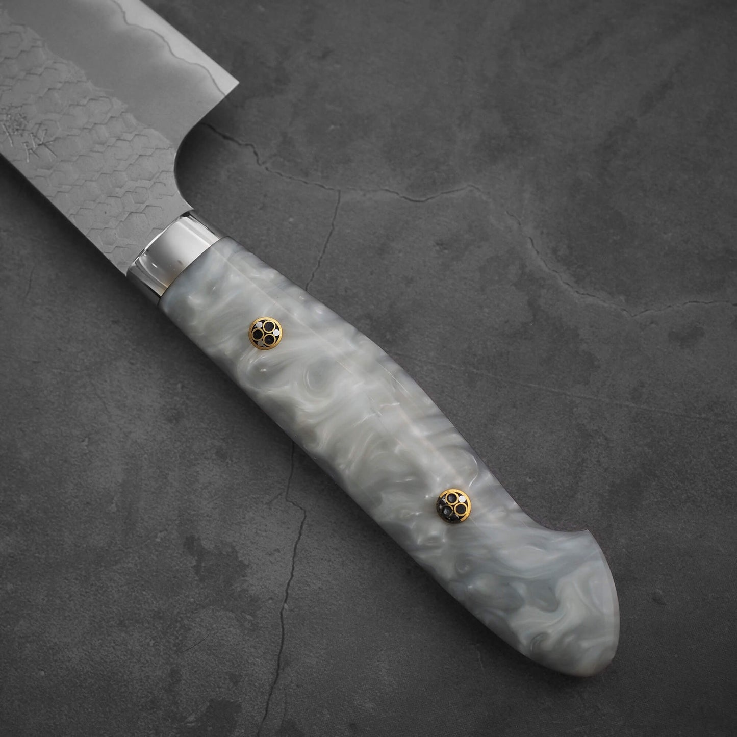 Close up view of the handle of 210mm Nigara tsuchime SG2 gyuto knife with pearl handle resin