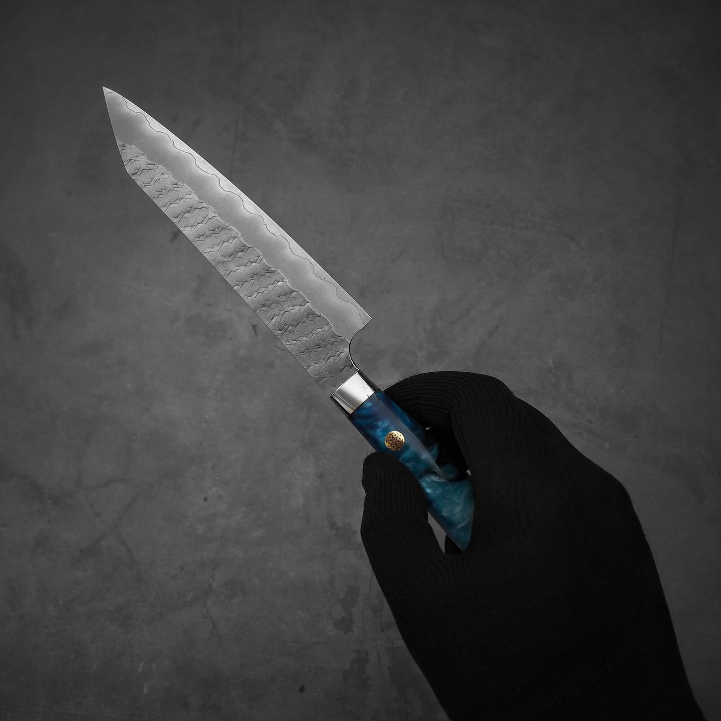 Hand holding Nigara tsuchime SG2 kiritsuke petty knife 150mm in a diagonal position
