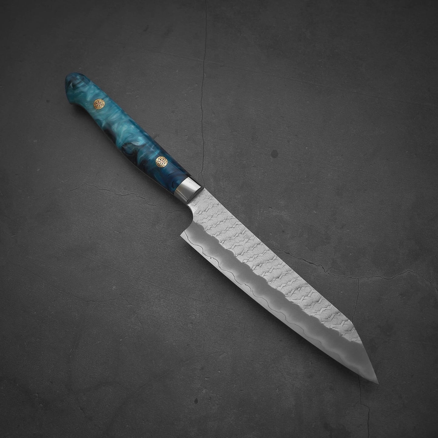 Top view of Nigara tsuchime SG2 kiritsuke petty knife 150mm in diagonal position with the tip facing the bottom right