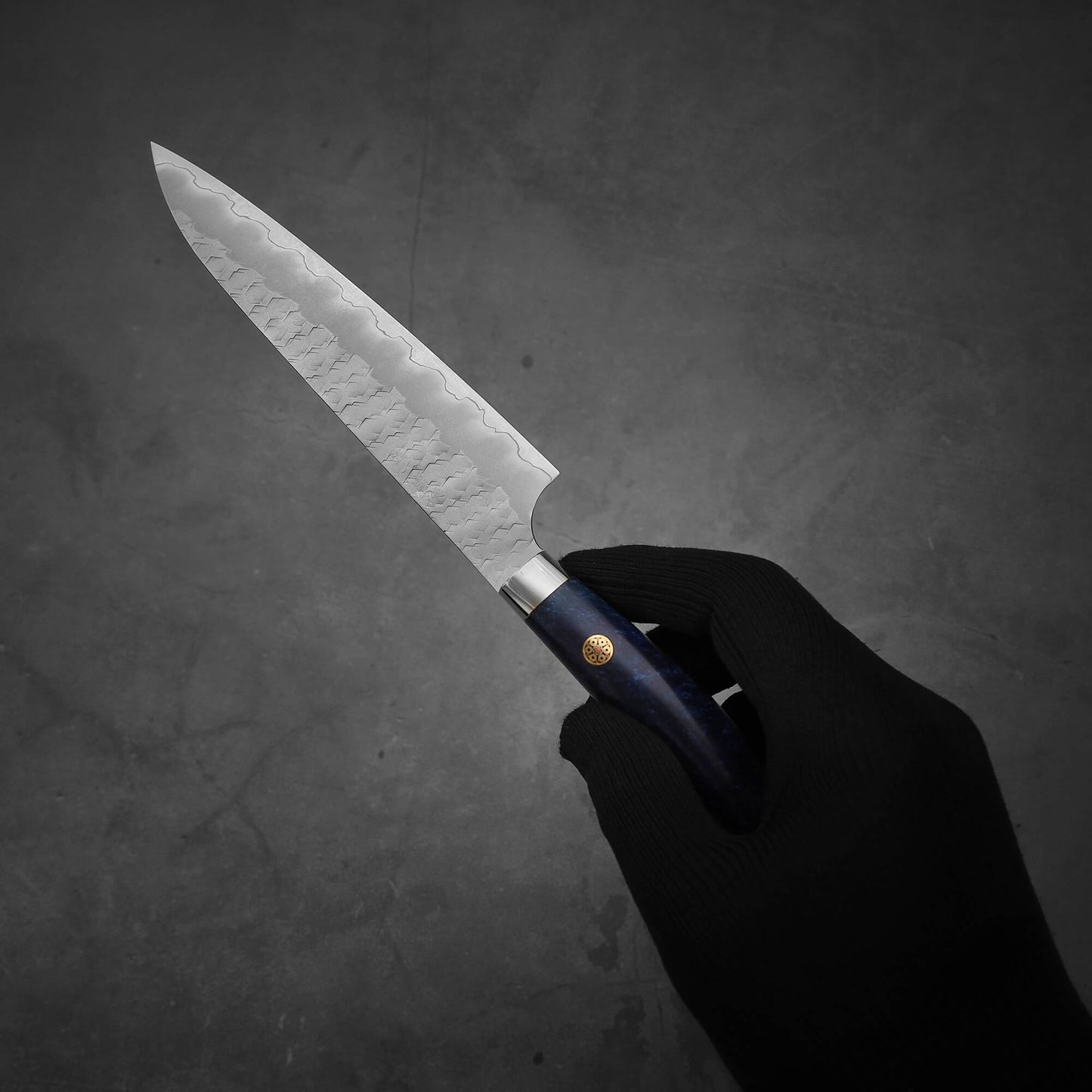 Hand holding Nigara tsuchime SG2 petty knife 150mm