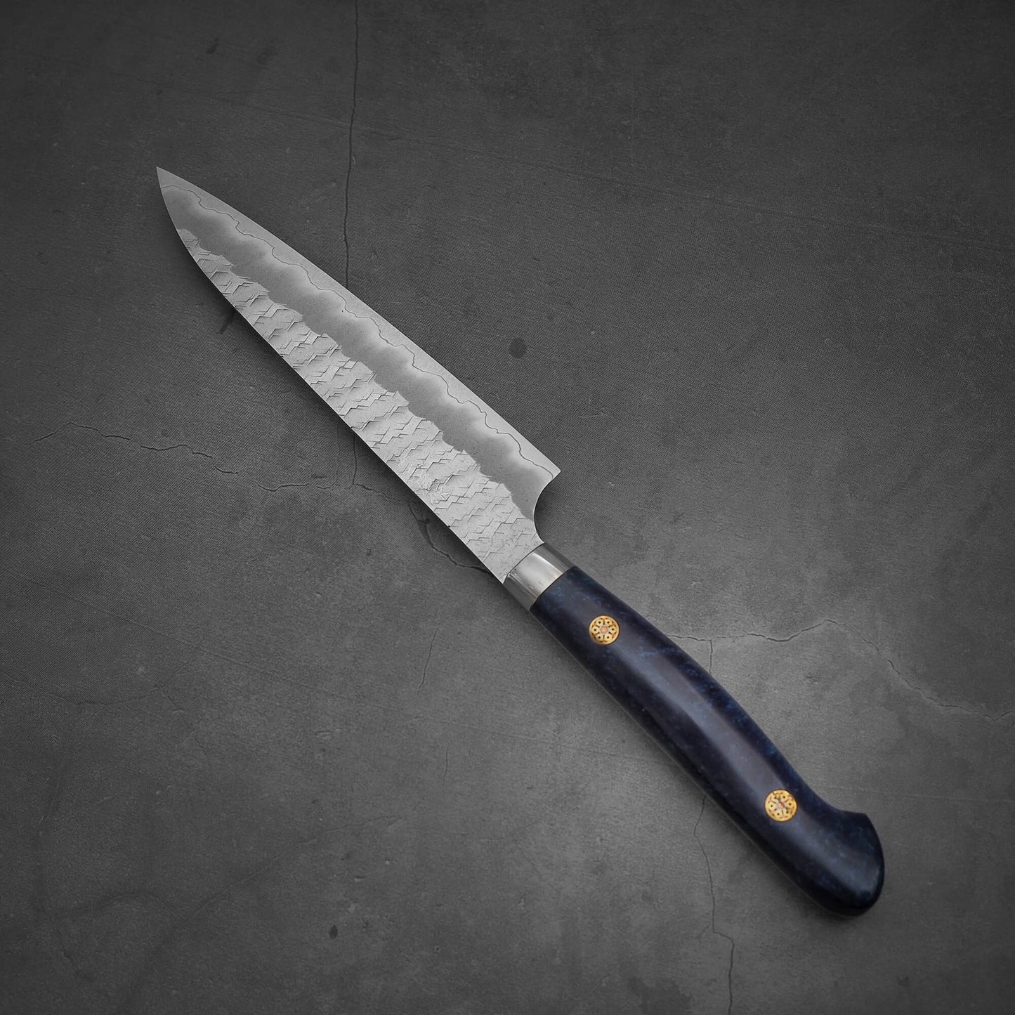 Top view of the Nigara tsuchime SG2 petty knife 150mm in a diagonal position where the tip is facing the upper left