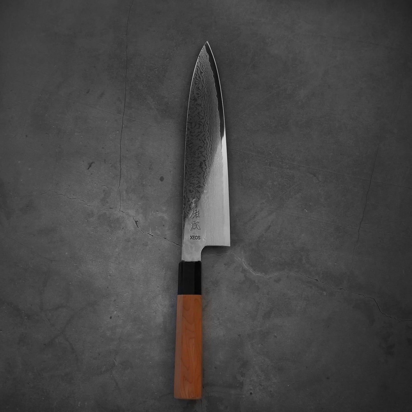 Top view of Sukenari damascus XEOS gyuto in vertical position