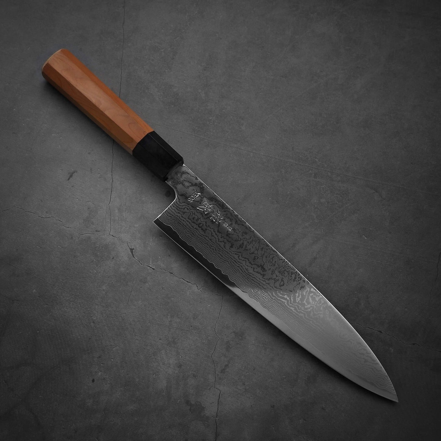 Top view of Sukenari damascus XEOS gyuto where the pointed tip is facing towards the lower right