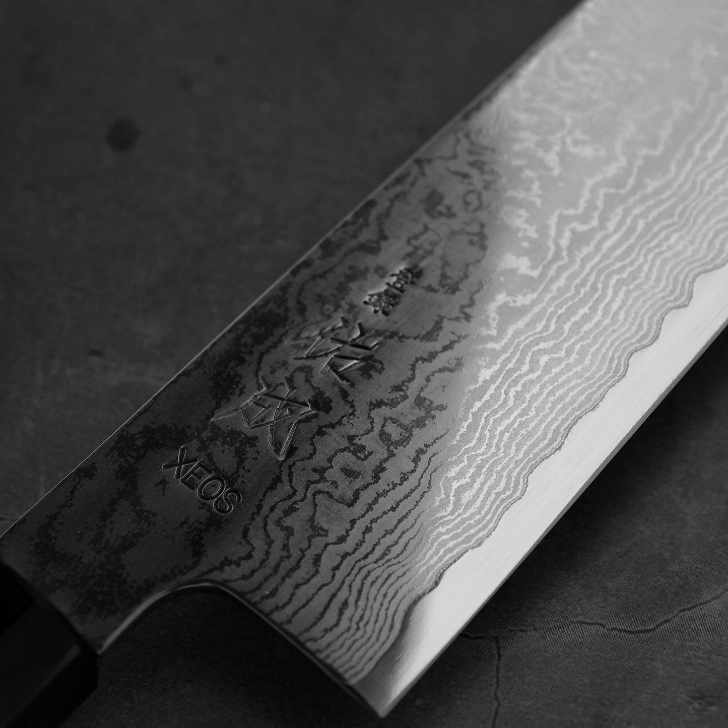 Close up view of the kanji area of Sukenari damascus XEOS gyuto
