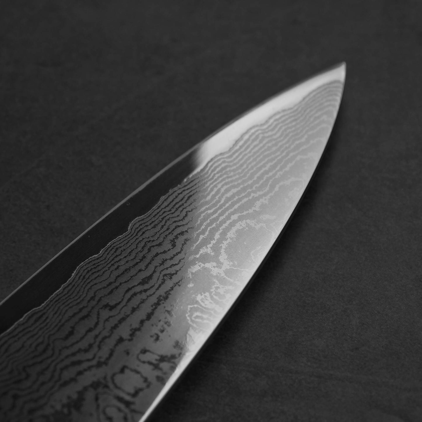 Close up view of the Sukenari damascus XEOS gyuto . Image shows the left side of the blade
