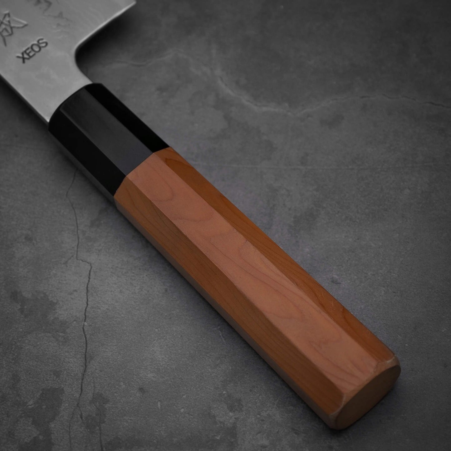 Close up view of the Japanese yew handle of Sukenari damascus XEOS gyuto