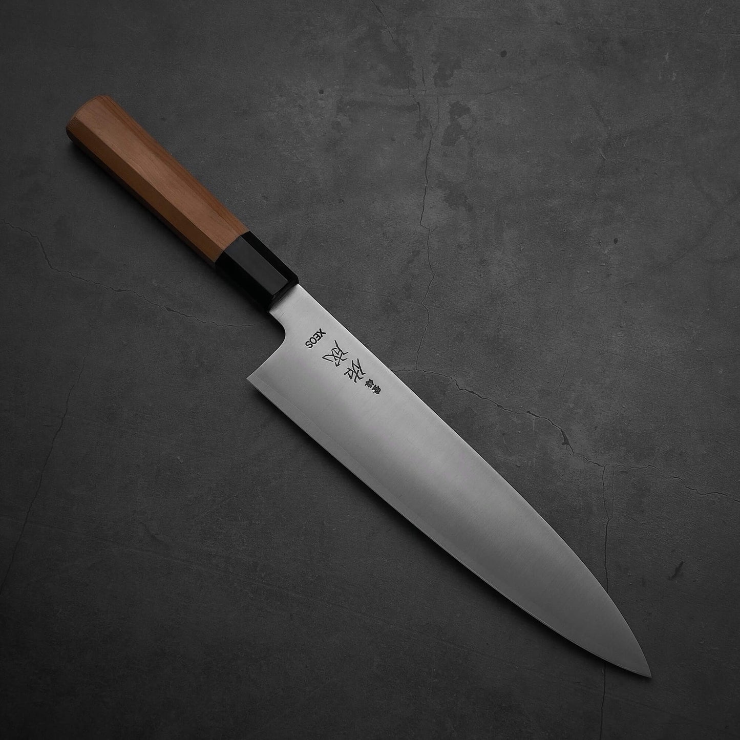 Top view of Sukenari XEOS gyuto 240mm where the pointed tip is facing towards the lower right