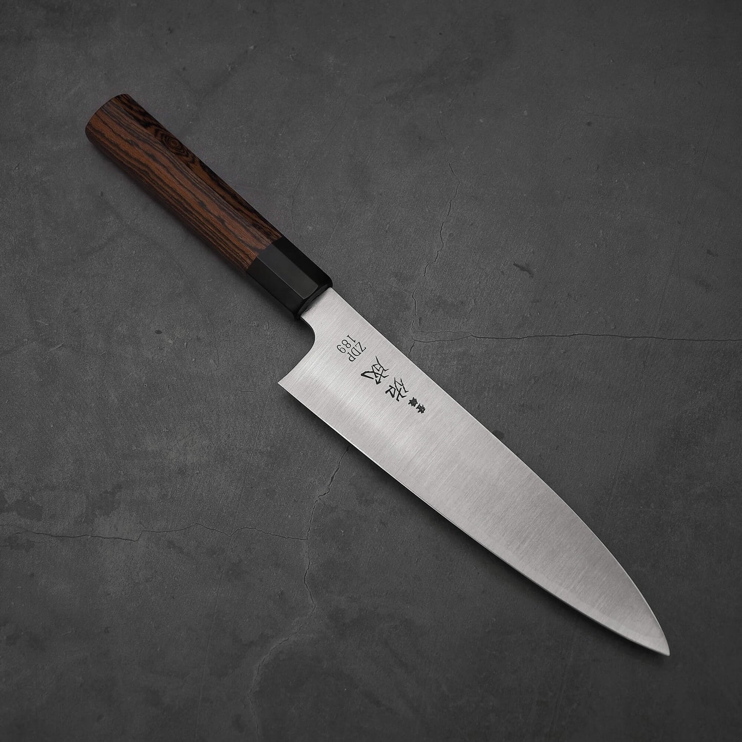 Top view of 210mm Sukenari ZDP189 gyuto knife where the pointed tip is facing towards the bottom right.